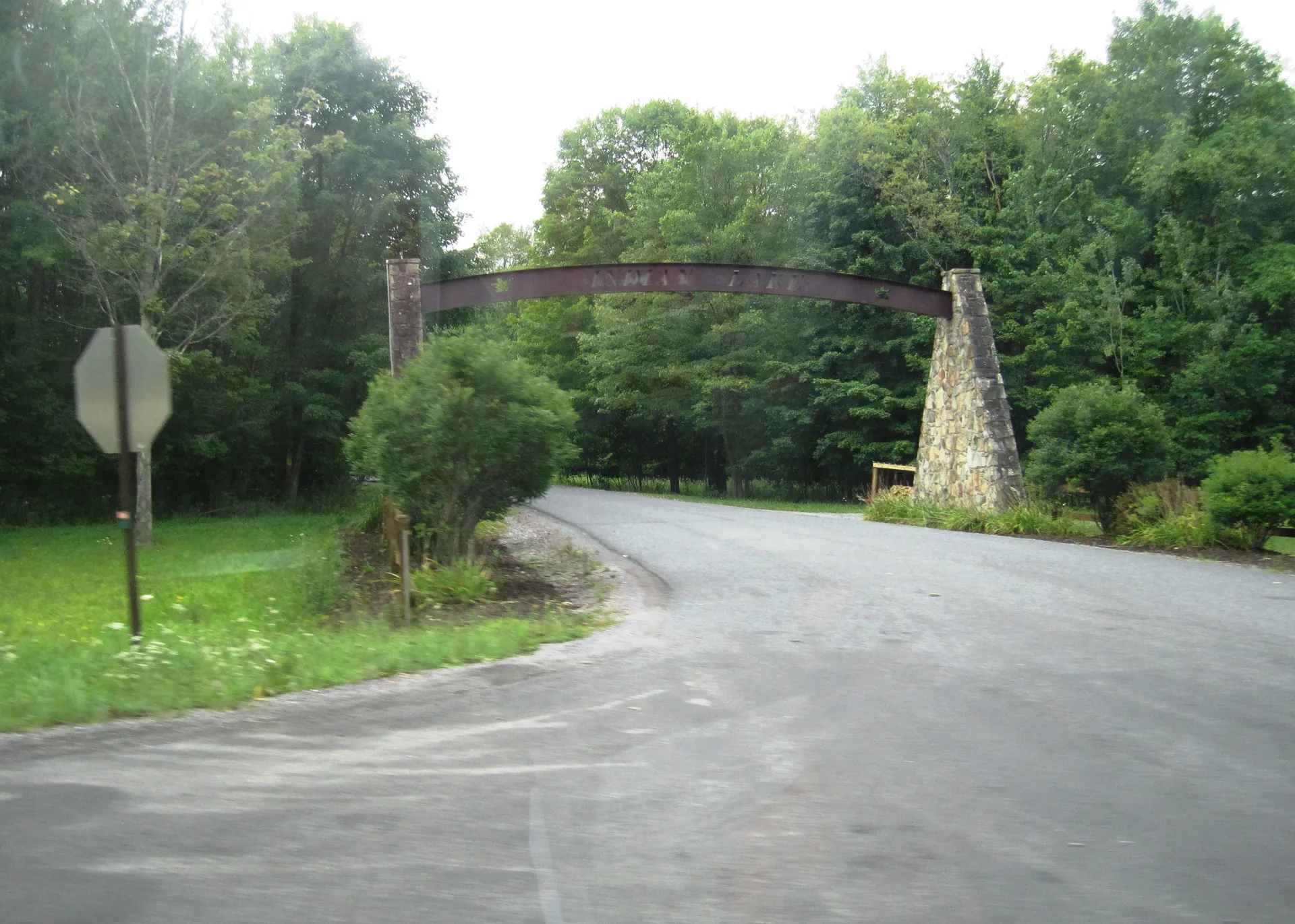 A rustic stone-and-timber arch over Peninsula Drive welcomes visitors to the lakeside borough of Indian Lake in Somerset County.