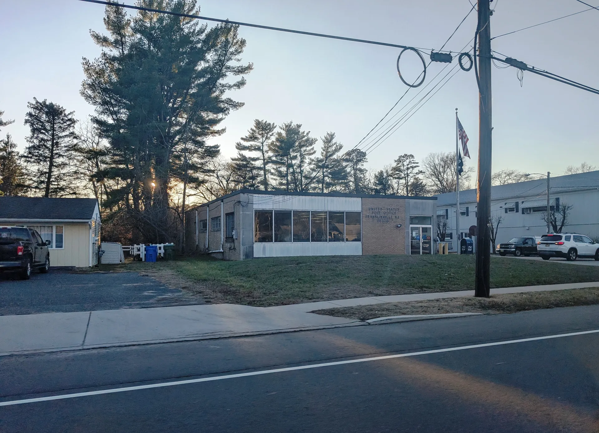 Franklinville's post office is a low building with a flat roof and large front windows, set back behind a lawn.