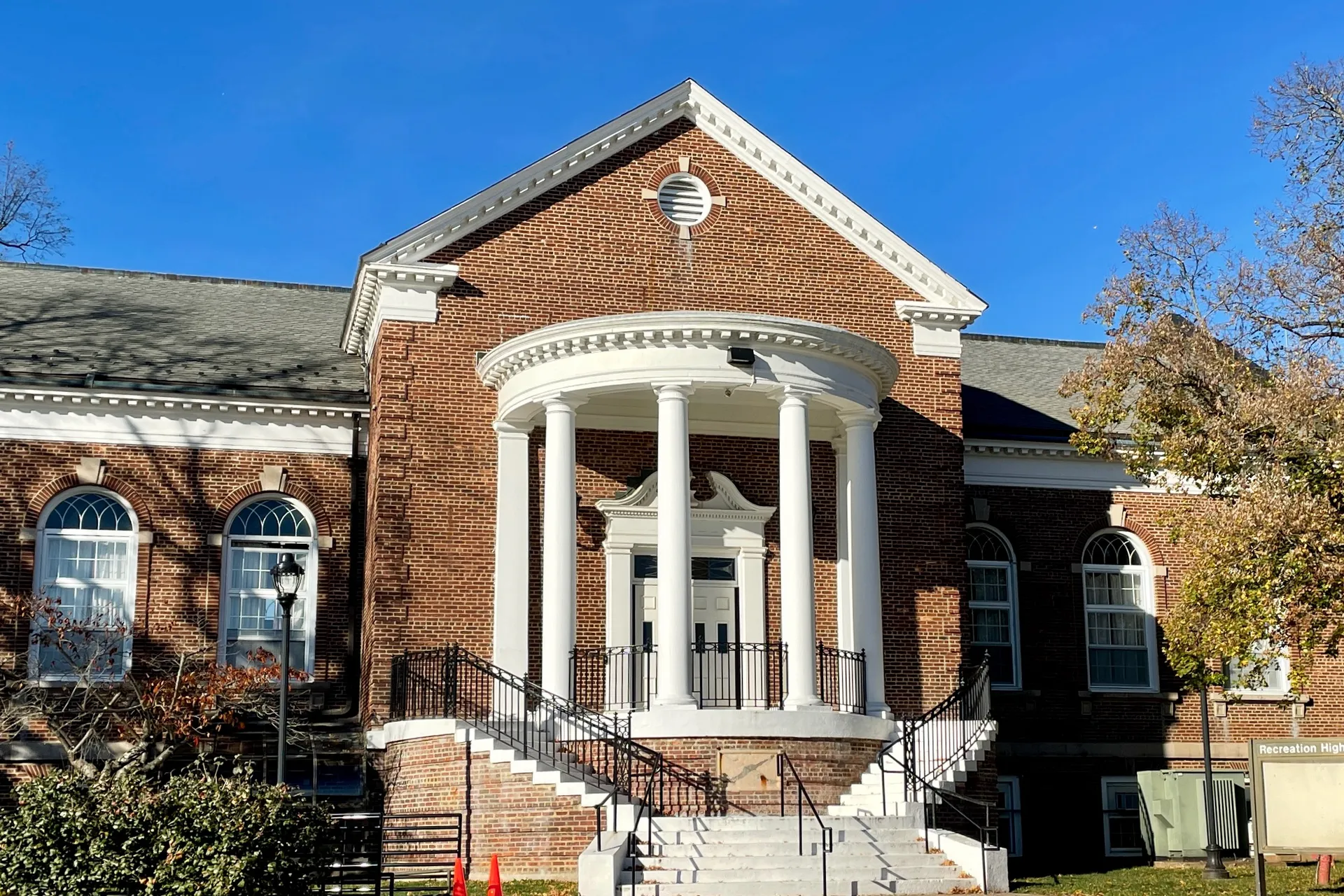 The Recreation Building at the Lyons VA Medical Center is a red brick building with a curved white columned portico.