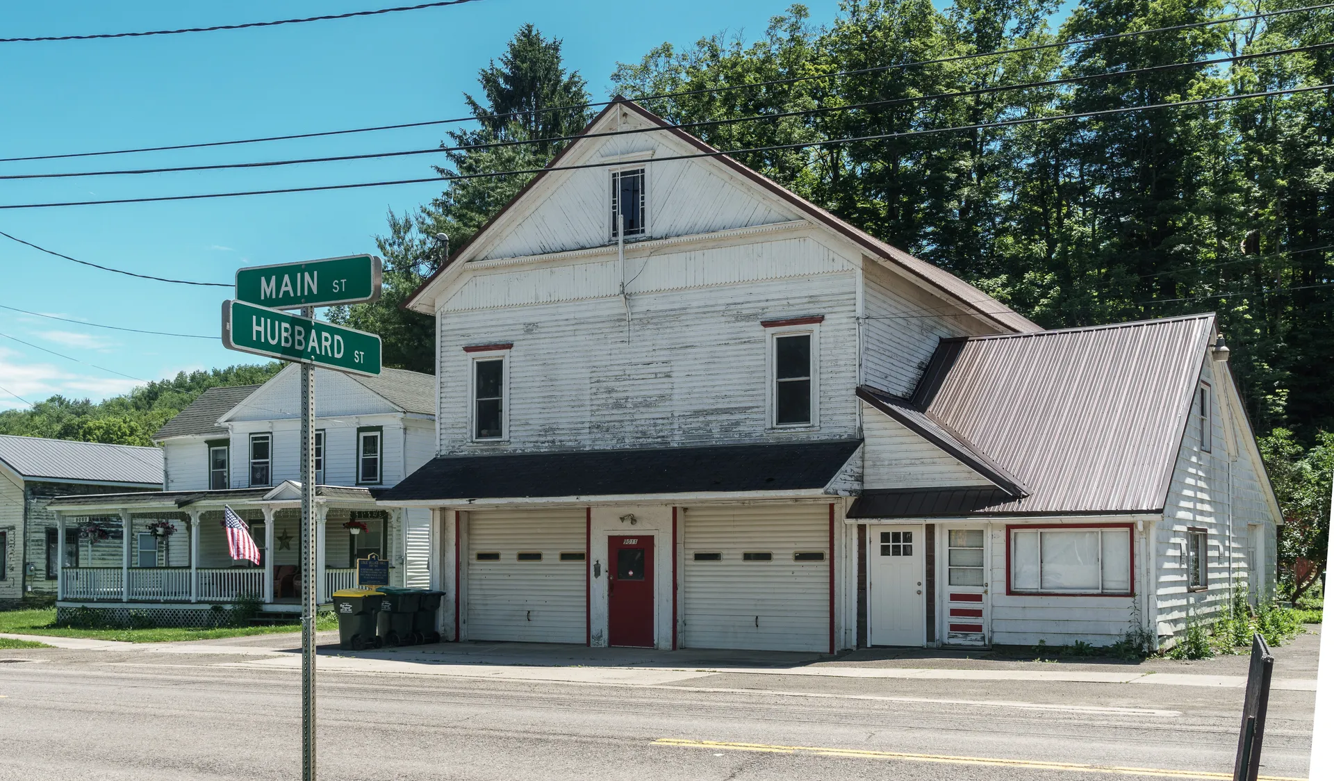 White Lisle Village Hall with garage bays in Lisle, New York.