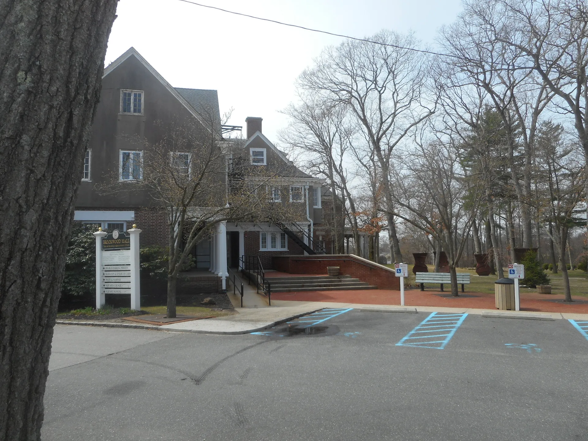 Historic Brookwood Hall mansion among trees in East Islip, New York.
