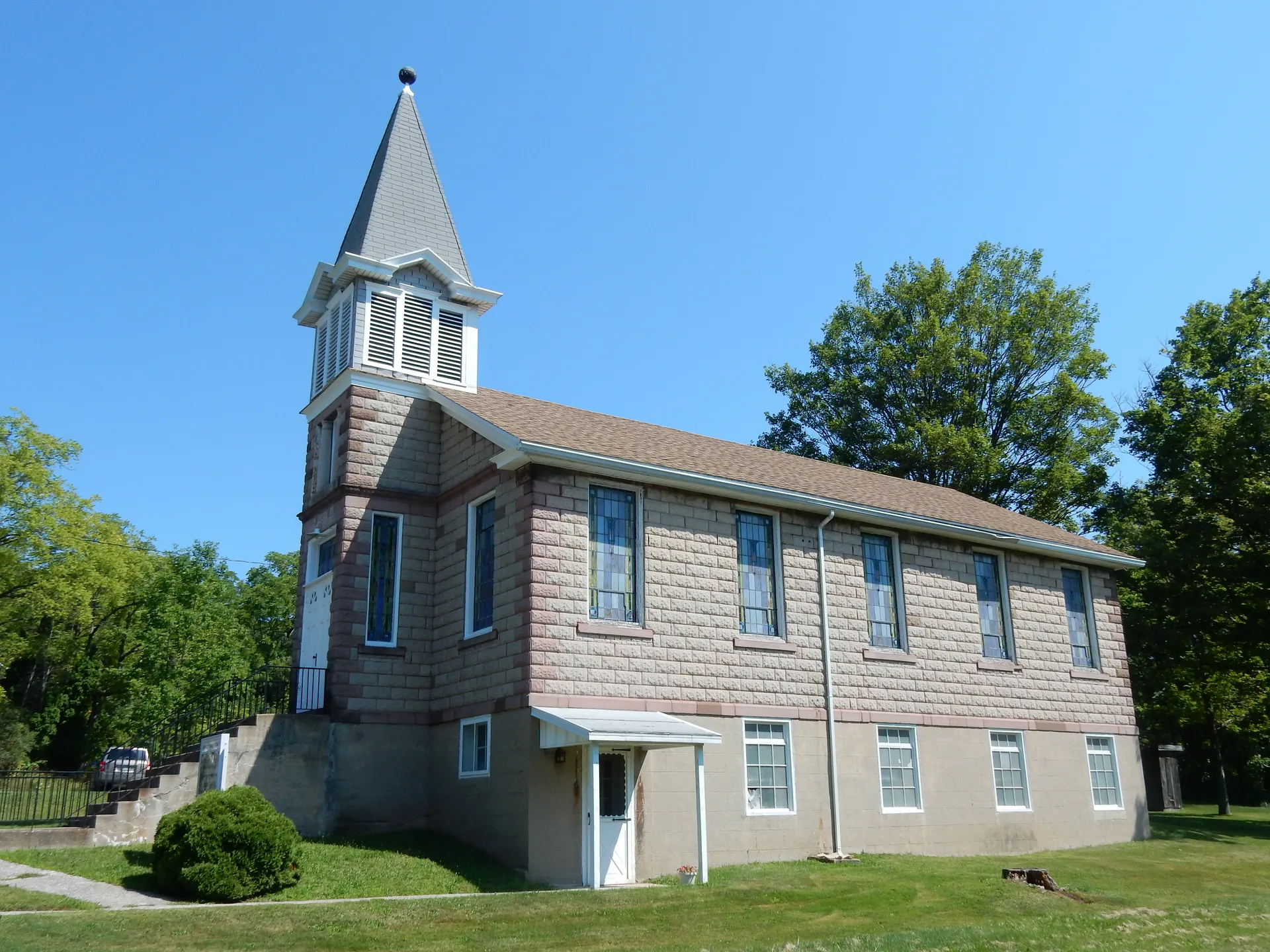 The Grier City Sunday School is a gray-shingled chapel with a pointed belfry on Grier Avenue in Rush Township.