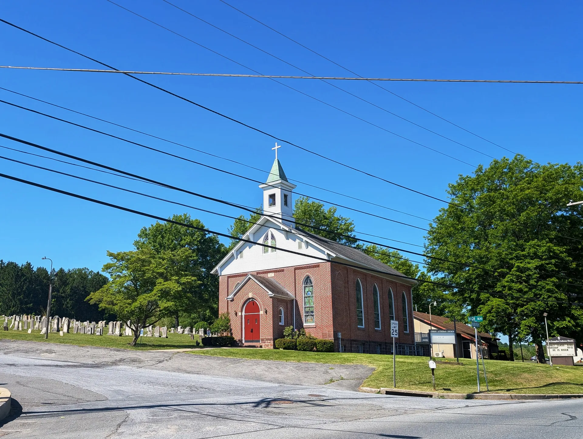 Christ Lutheran Church in Grill is a red-brick church with a white cupola and cemetery beside Philadelphia Avenue.