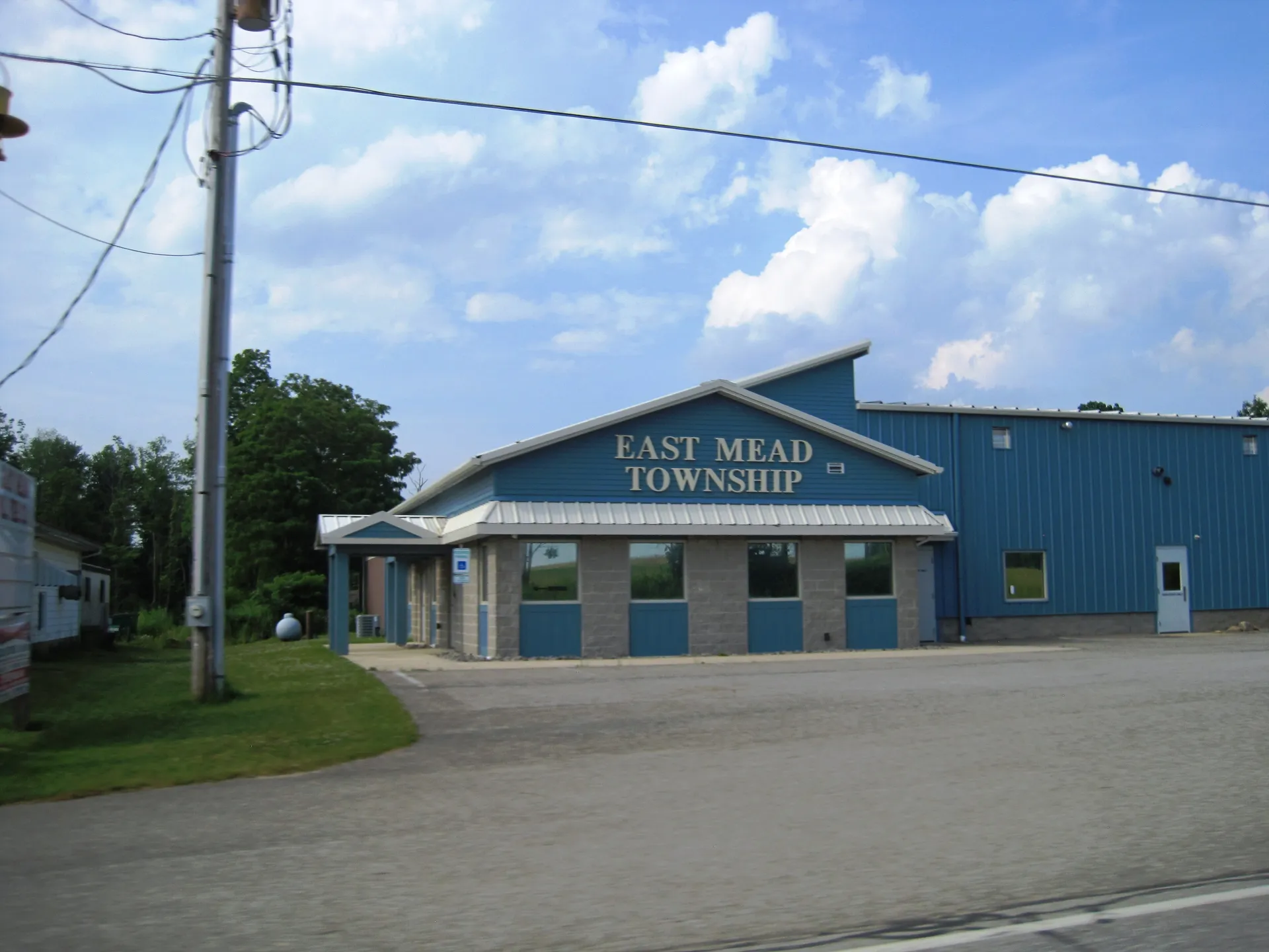 East Mead Township's municipal building is a blue-and-gray metal building with its name in large letters above the entrance.
