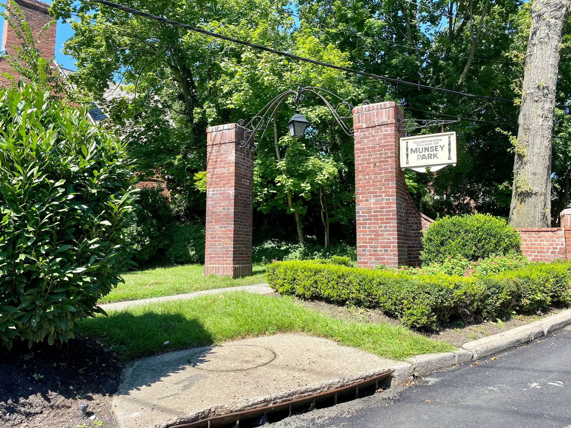 Brick entrance piers with landscaping at Munsey Park, New York.
