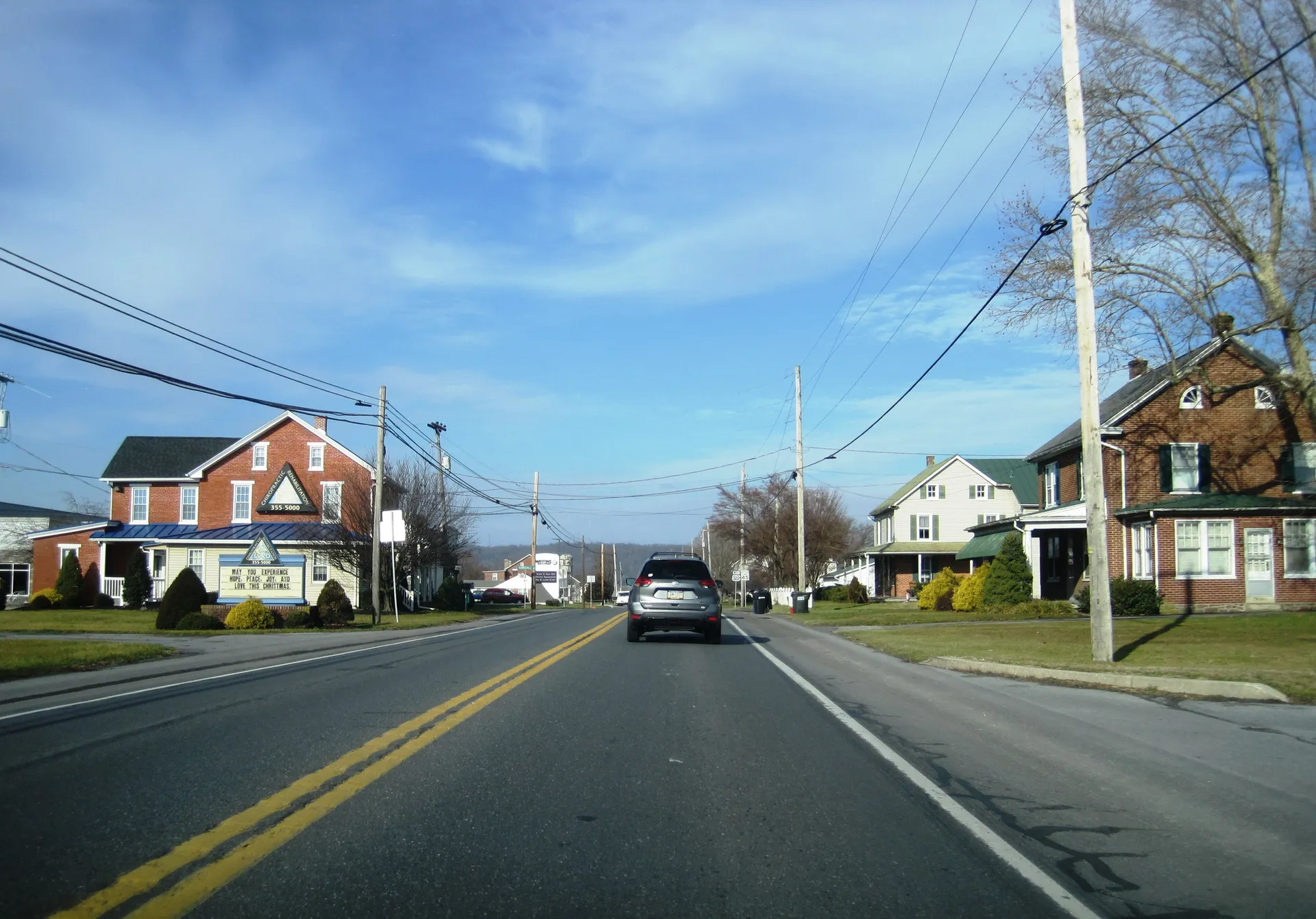 U.S. Route 322 runs through Hinkletown in Earl Township, past a red-brick farmhouse and porch-fronted homes.