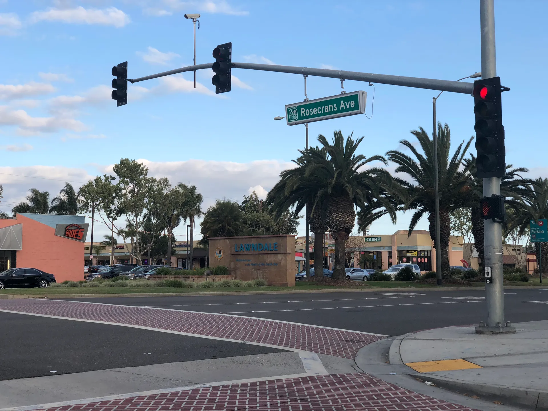 A street intersection with palm trees and roadside buildings in Lawndale, California, in May 2018.