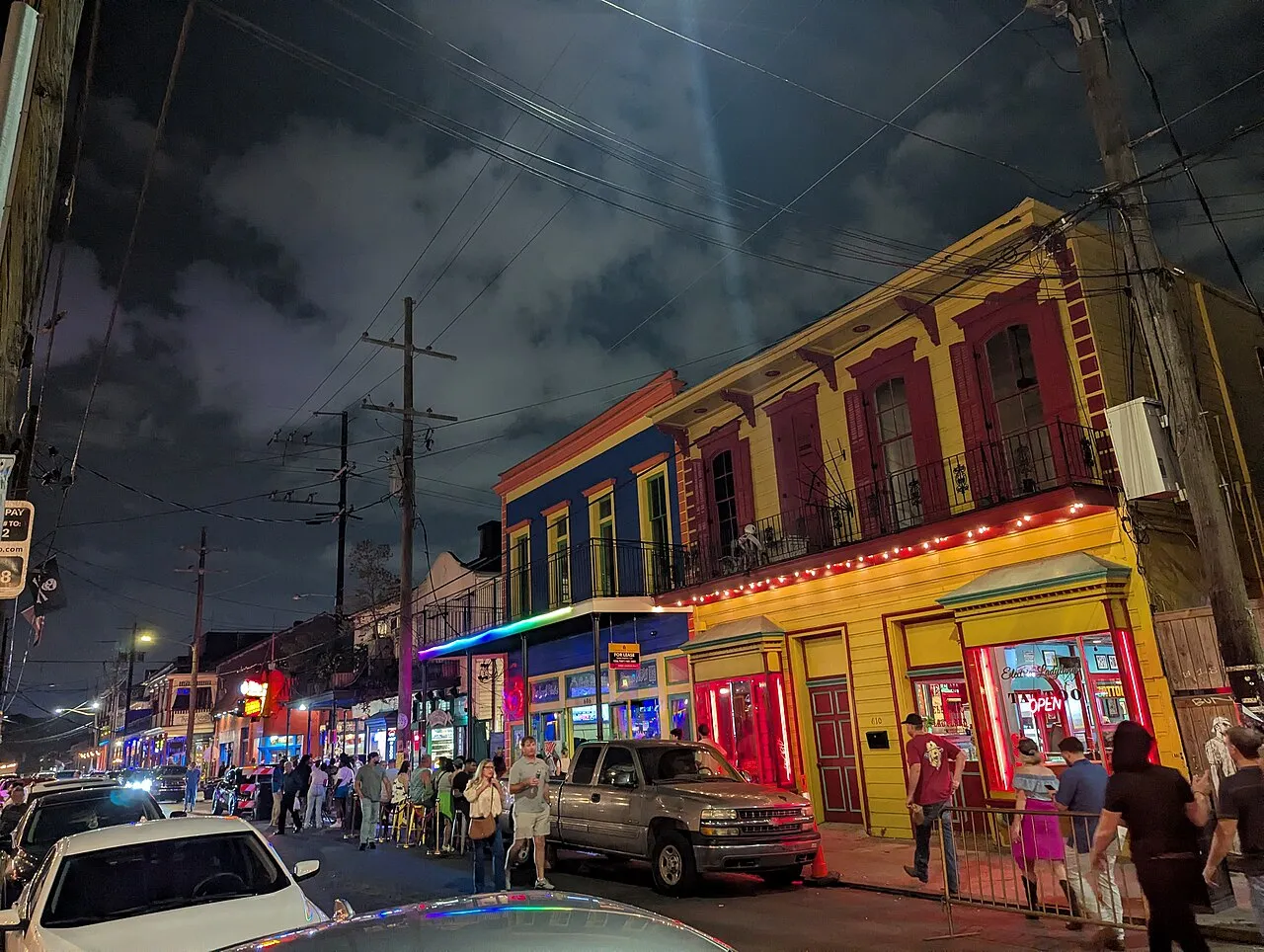 Colorful buildings, illuminated storefronts and evening pedestrians on the 600 block of Frenchmen Street in Marigny, photographed November 22, 2025.
