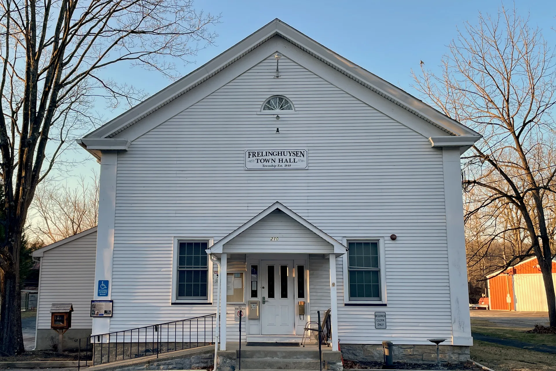 The building at 210 Main Street in Johnsonburg is a white clapboard hall with a gabled front and a small porch.