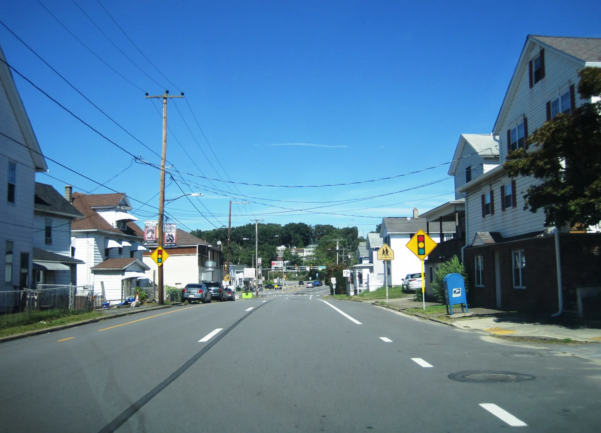 Chestnut Street (Route 315) runs north through Dupont past homes, a yellow warning sign and hills on the horizon.