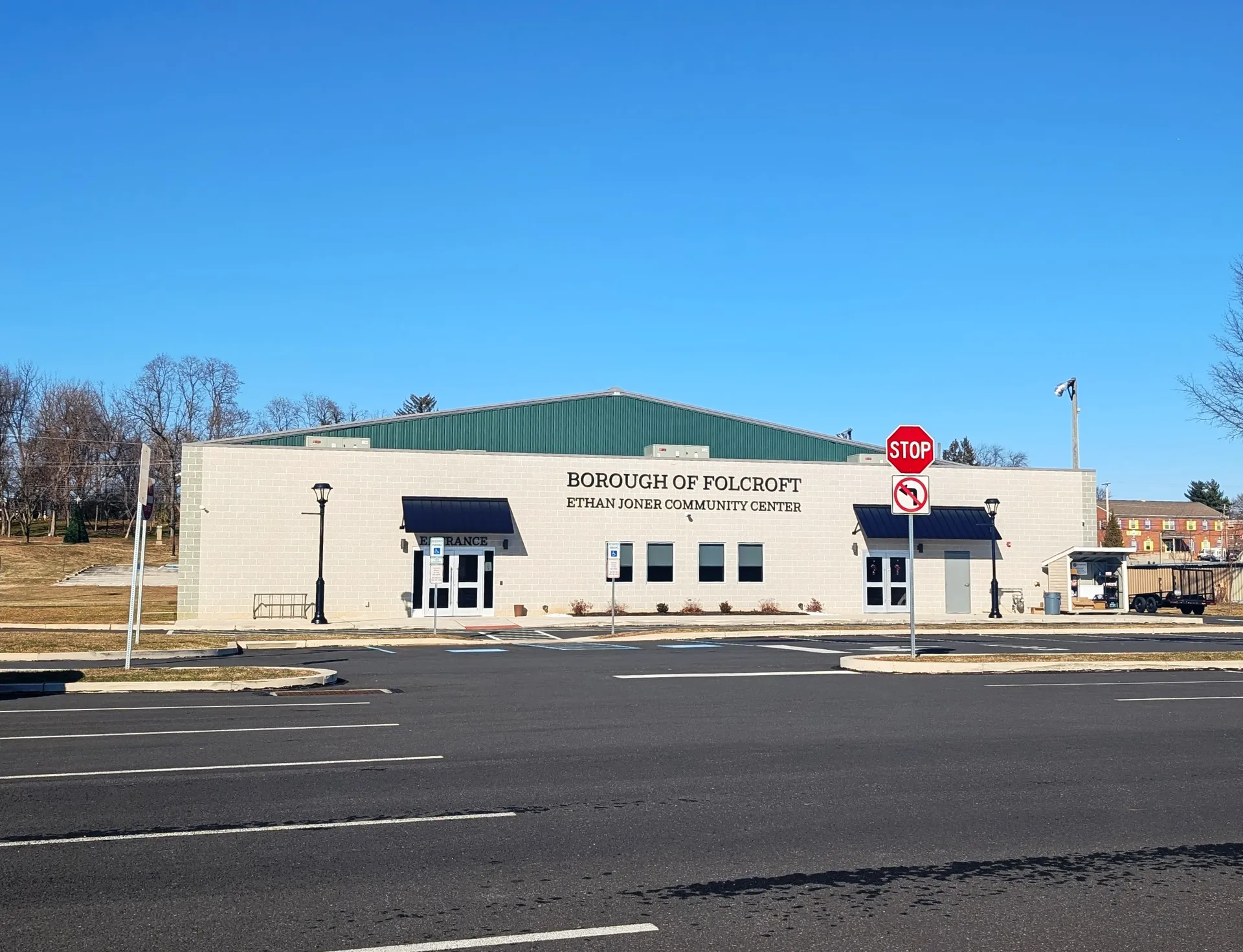 The Ethan Joner Community Center in Folcroft is a modern single-story building with a sign above its glass entry.