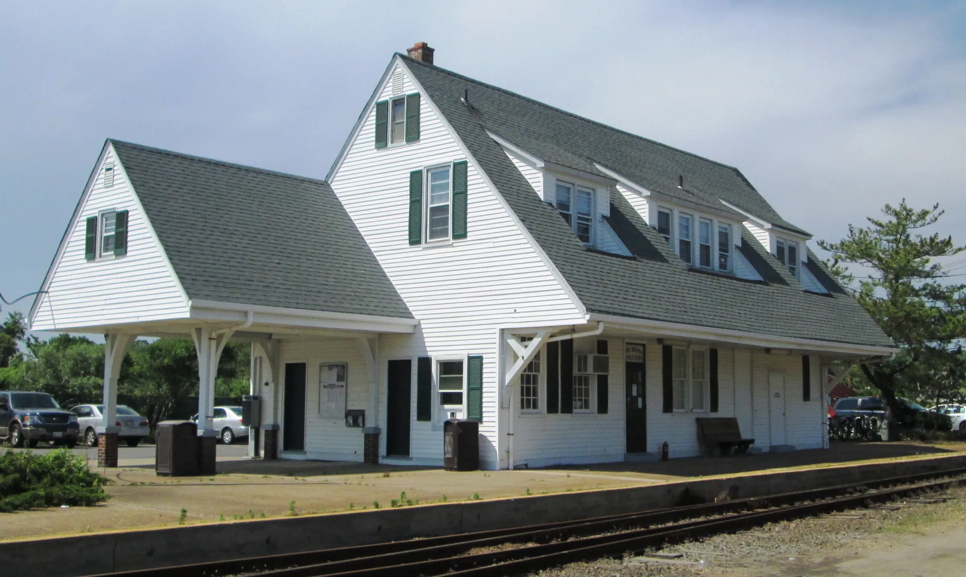 Historic white Montauk station house beside the tracks in Montauk, New York.