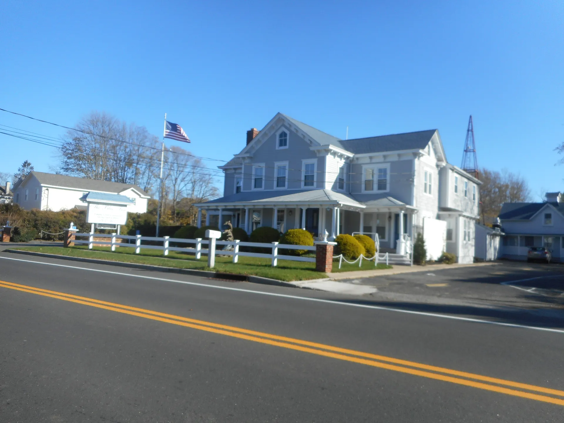 Historic Blue Inn building with a flag in East Marion, New York.