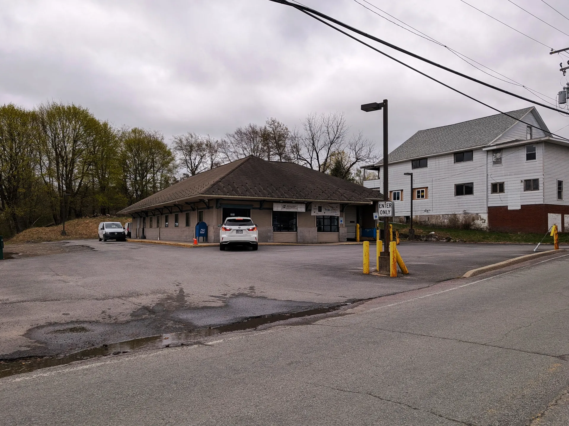 The Gouldsboro post office is a small brown-roofed building with a covered entrance on Main Street in Lehigh Township.