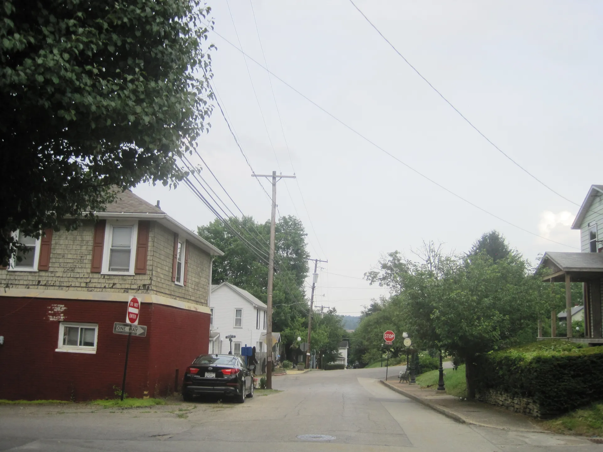 Third Avenue in Homewood runs east between Brighton and School streets past a red brick-and-siding house and leafy trees.