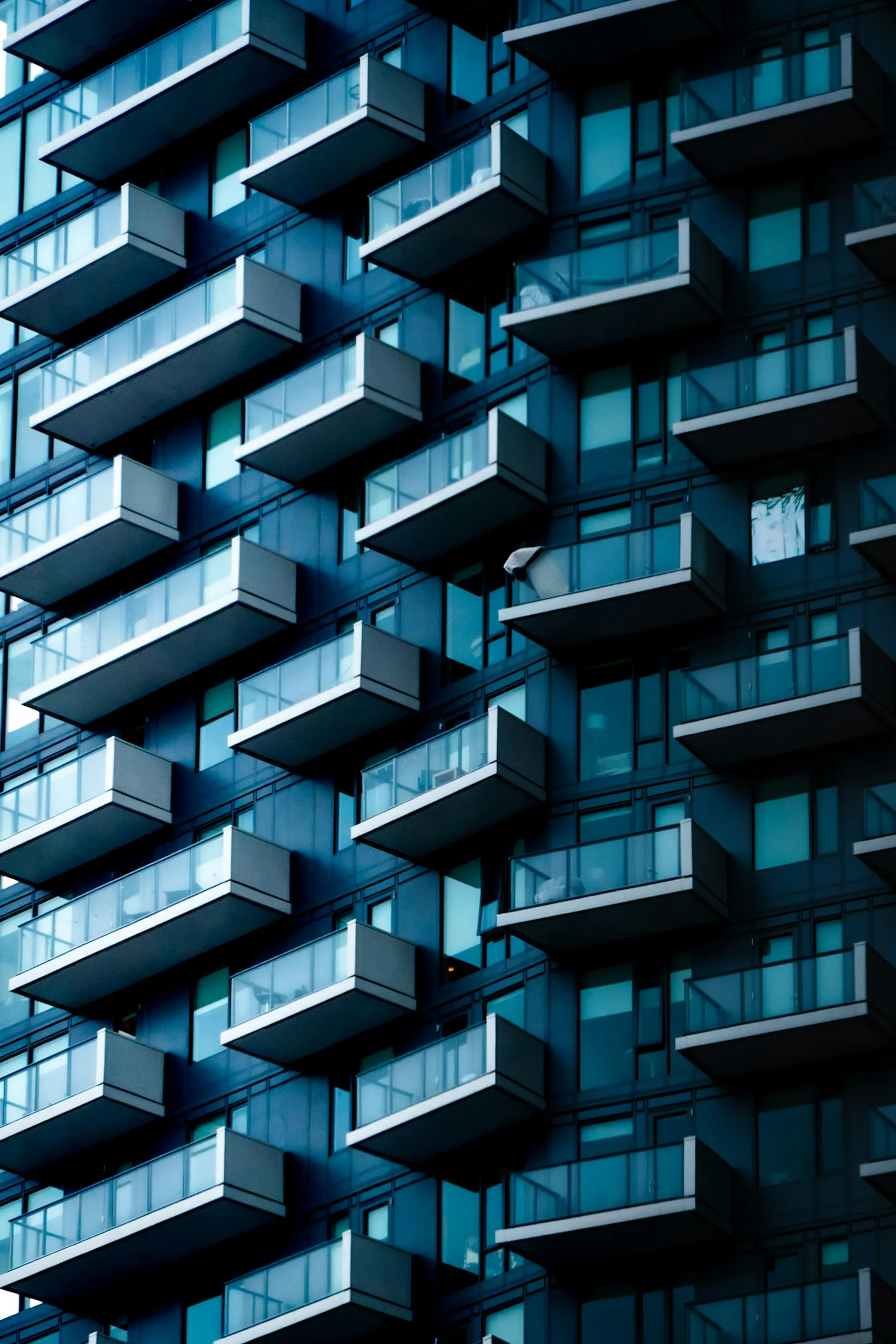 Modern apartment building with glass balconies.