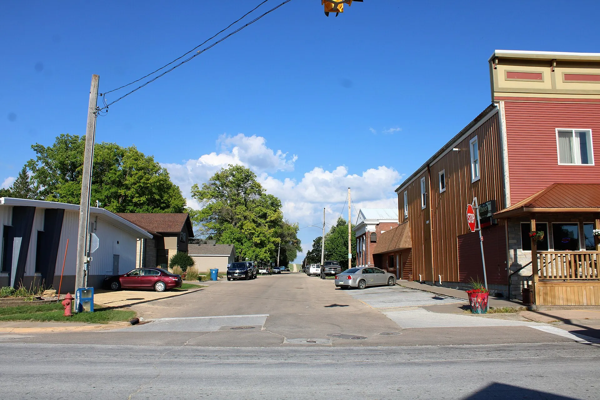 Small-town street with brick building in Donahue, Iowa.
