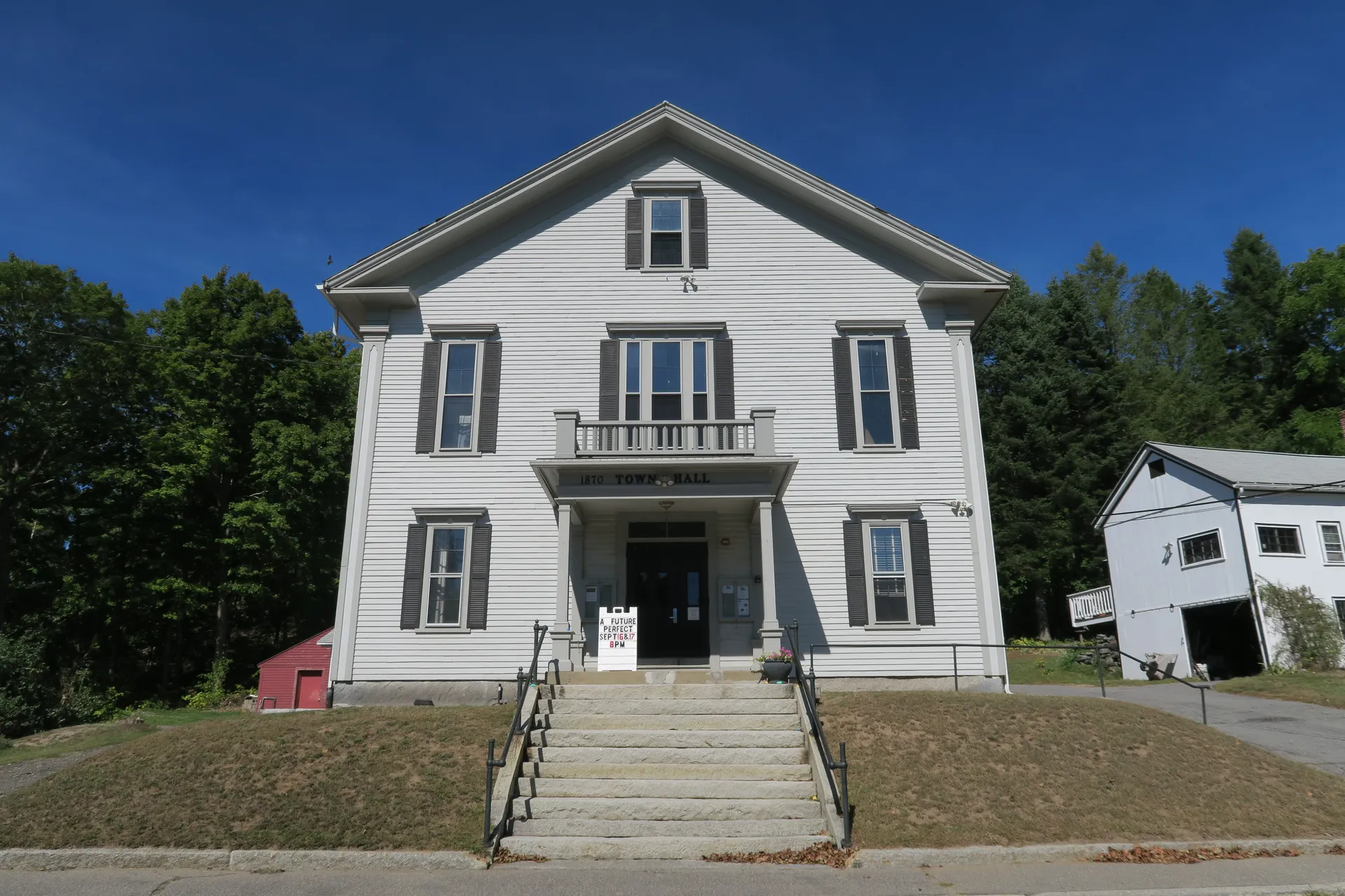 Historic white Berlin Town Hall with columns in Berlin, Massachusetts.