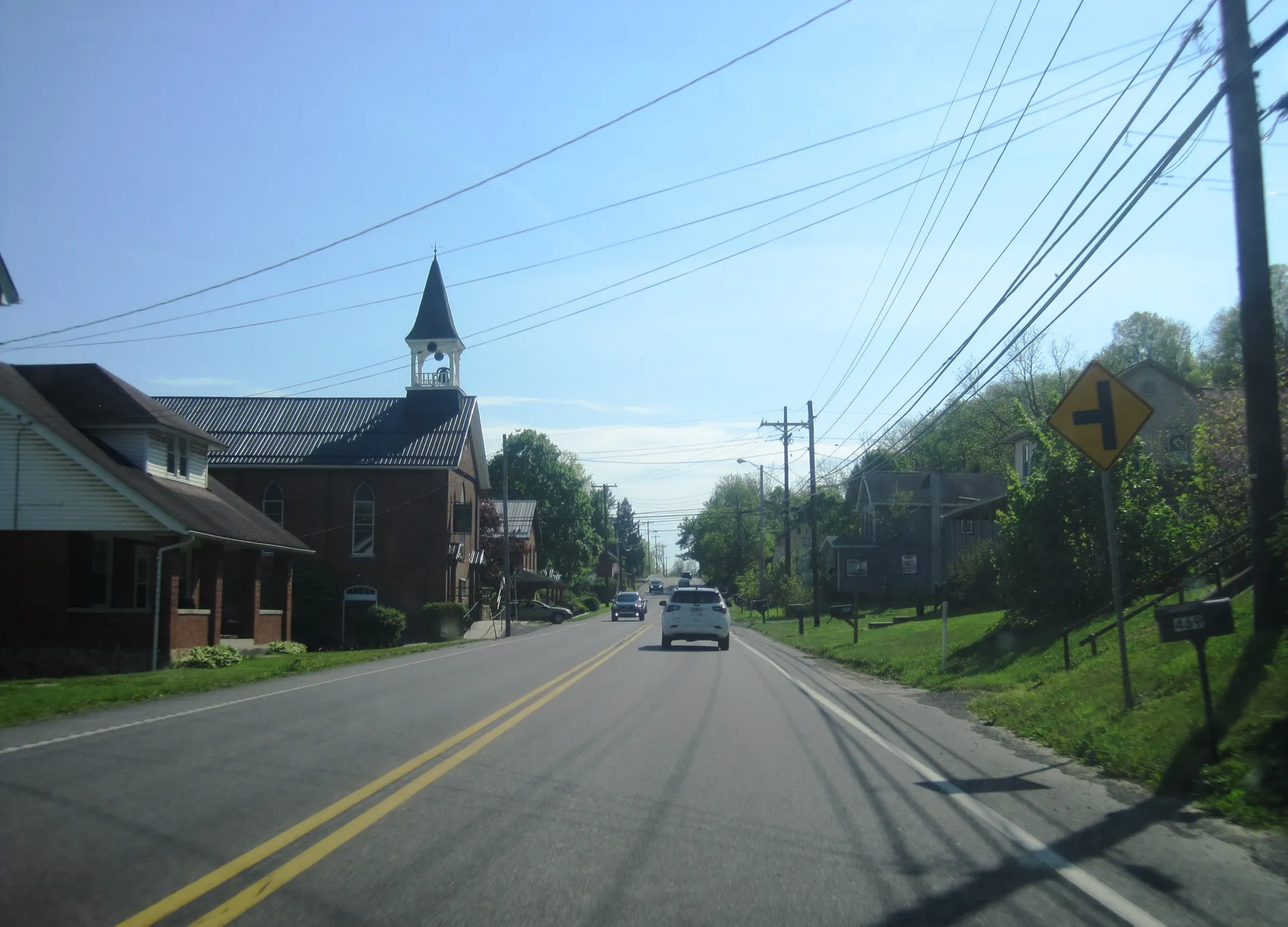 U.S. Route 22 passes a red-brick church with a white belfry in Geeseytown, a village in Frankstown Township.