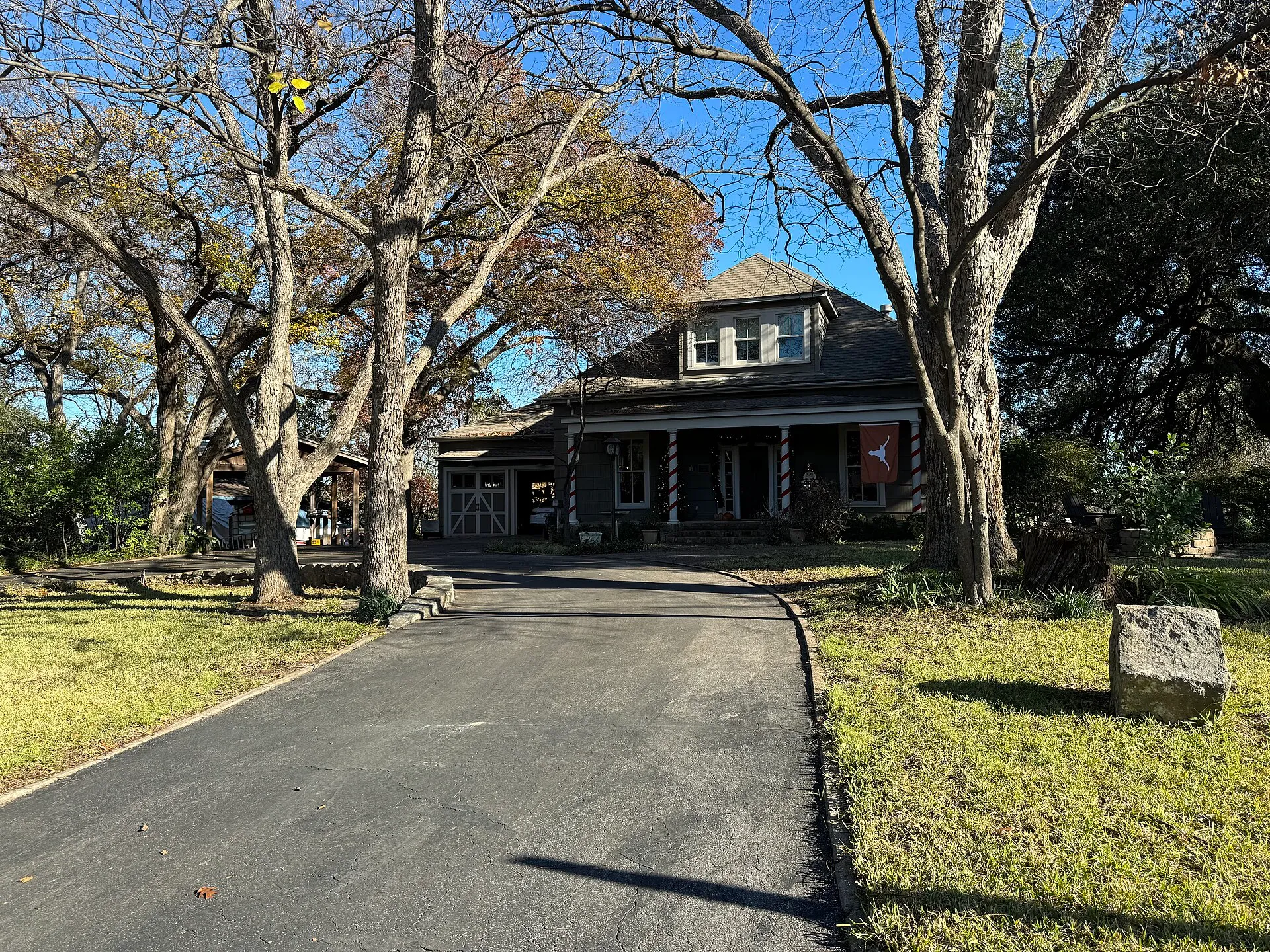 Historic Splitrock Burns-Klein House among oak trees in Austin, Texas.