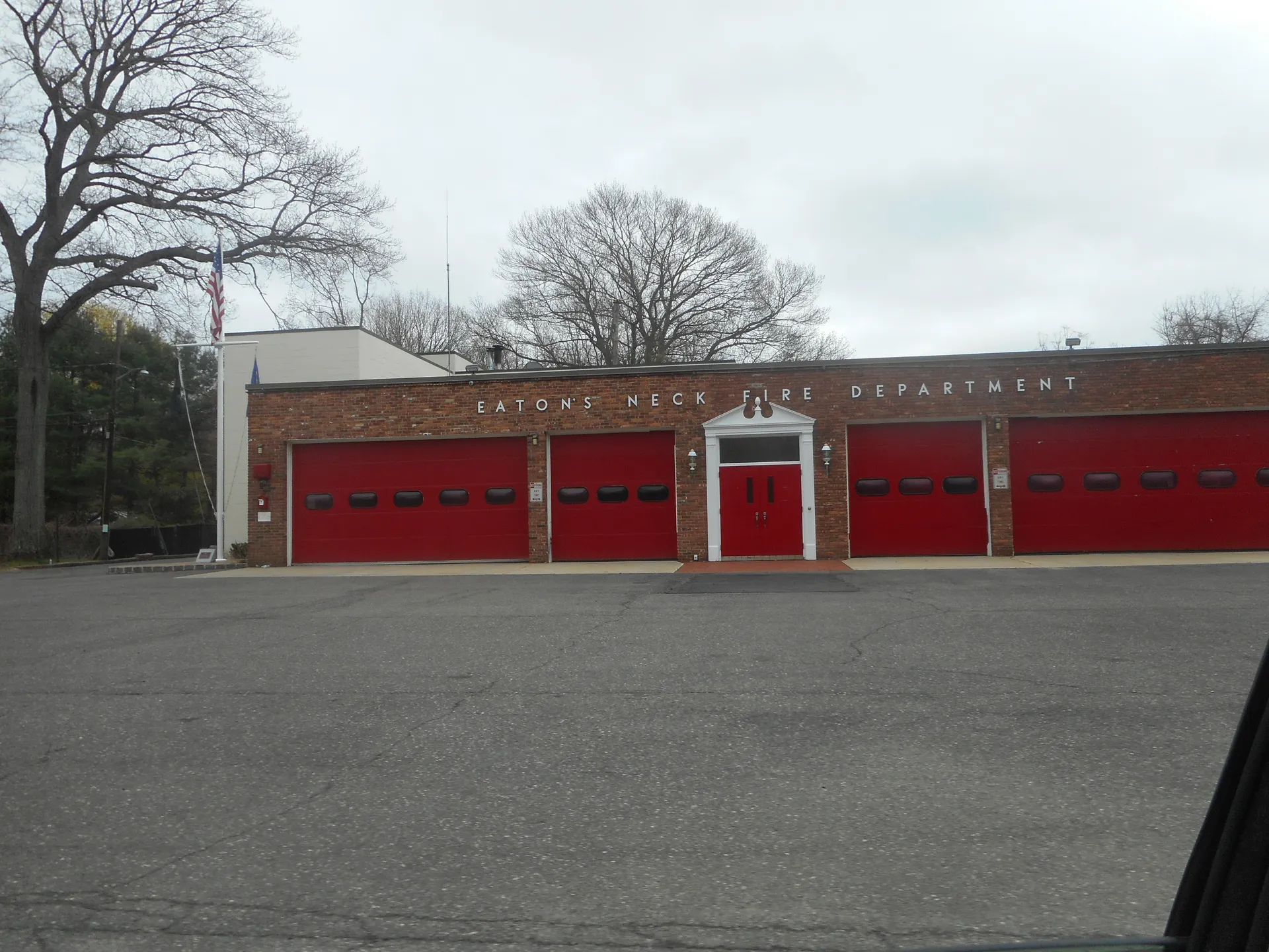 Eaton's Neck Fire Department firehouse with red bay doors in Eatons Neck, New York.