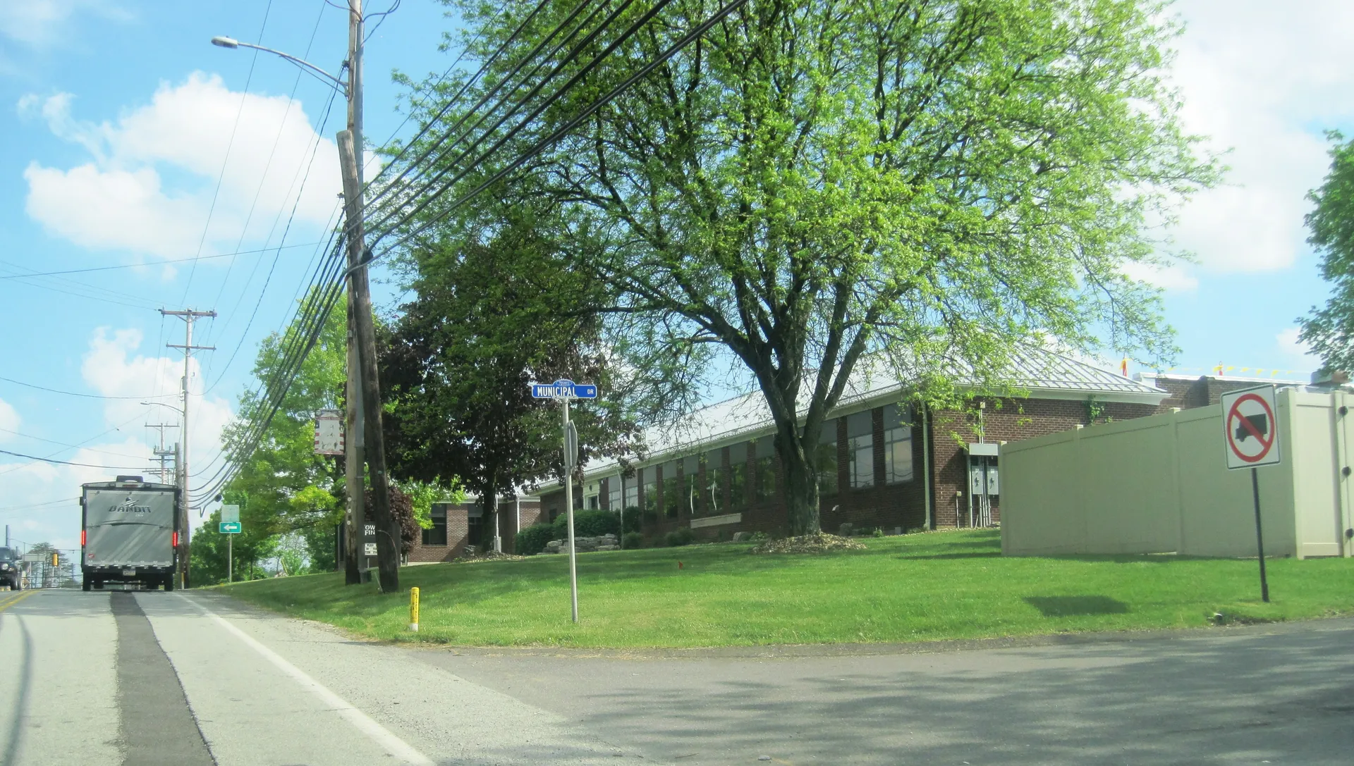 Findlay Township's municipal building is a long brick structure set behind large shade trees at Route 30 and Municipal Drive.