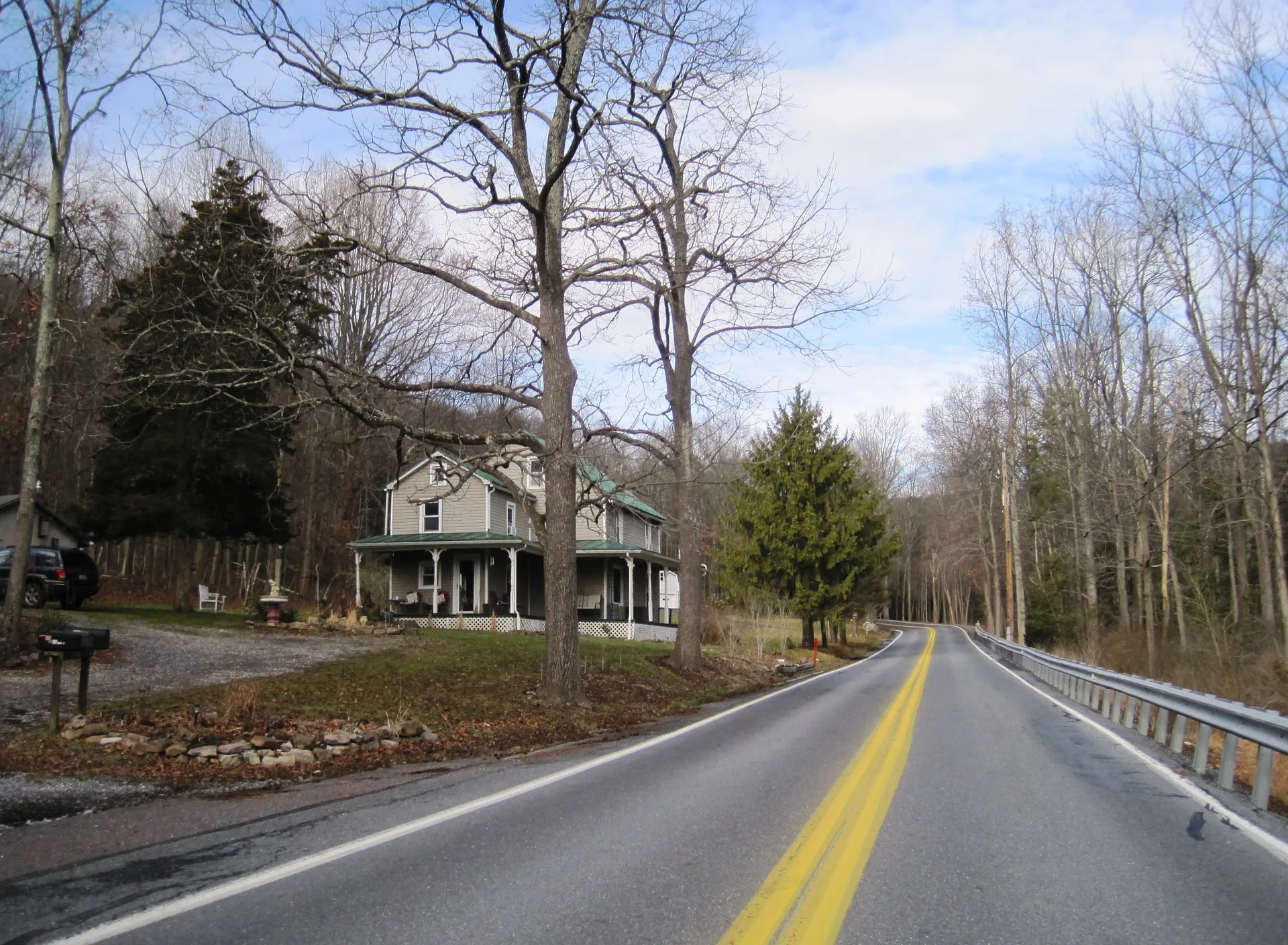 Gold Mine Road heads north past a white farmhouse and tall bare trees in rural Cold Spring Township, Lebanon County.