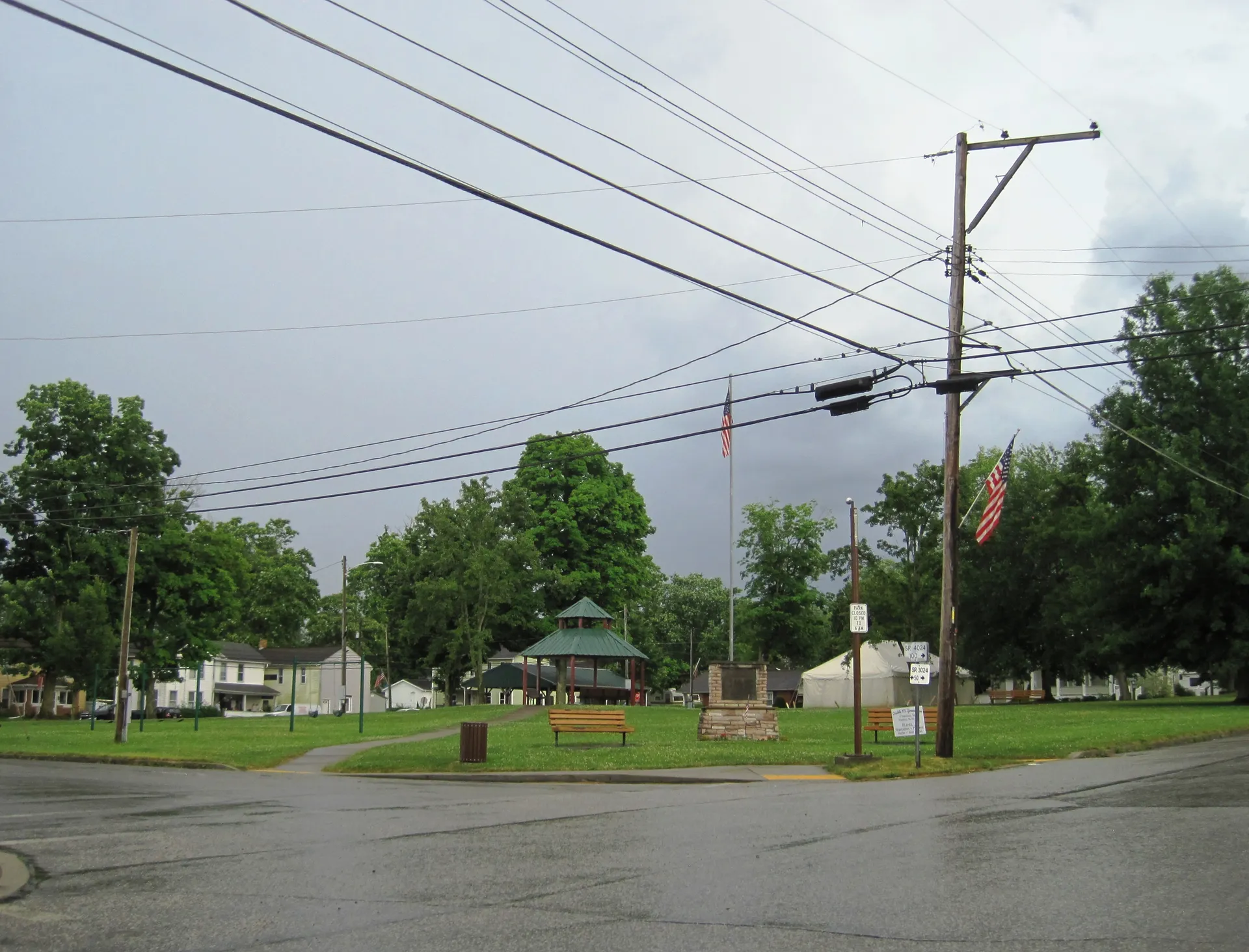Main Street at 2nd Street in Fredonia looks toward the borough park, where a gazebo sits beneath leafy trees.