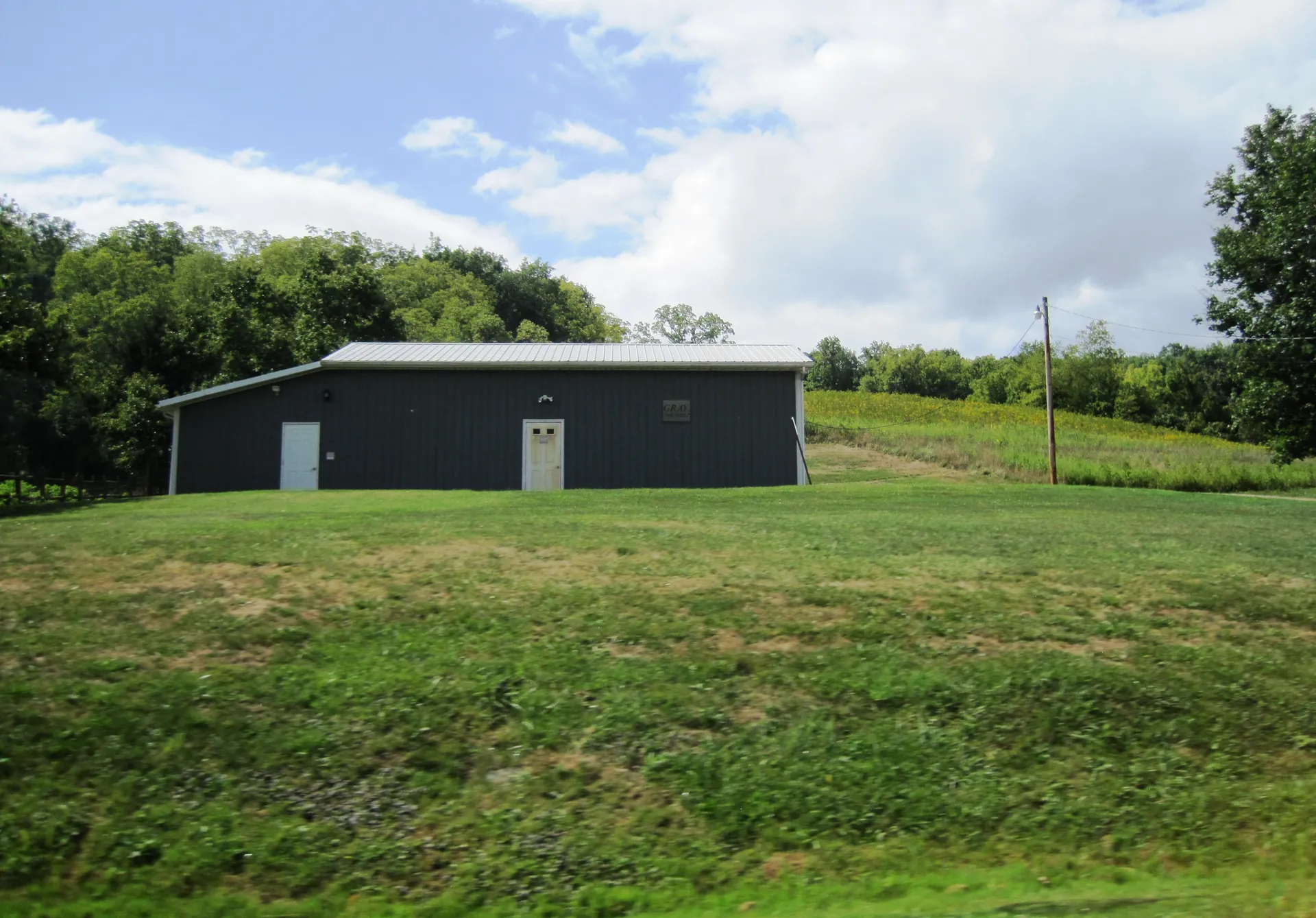 Gray Township's municipal building is a dark green metal building on a grassy rise off Stringtown Road.