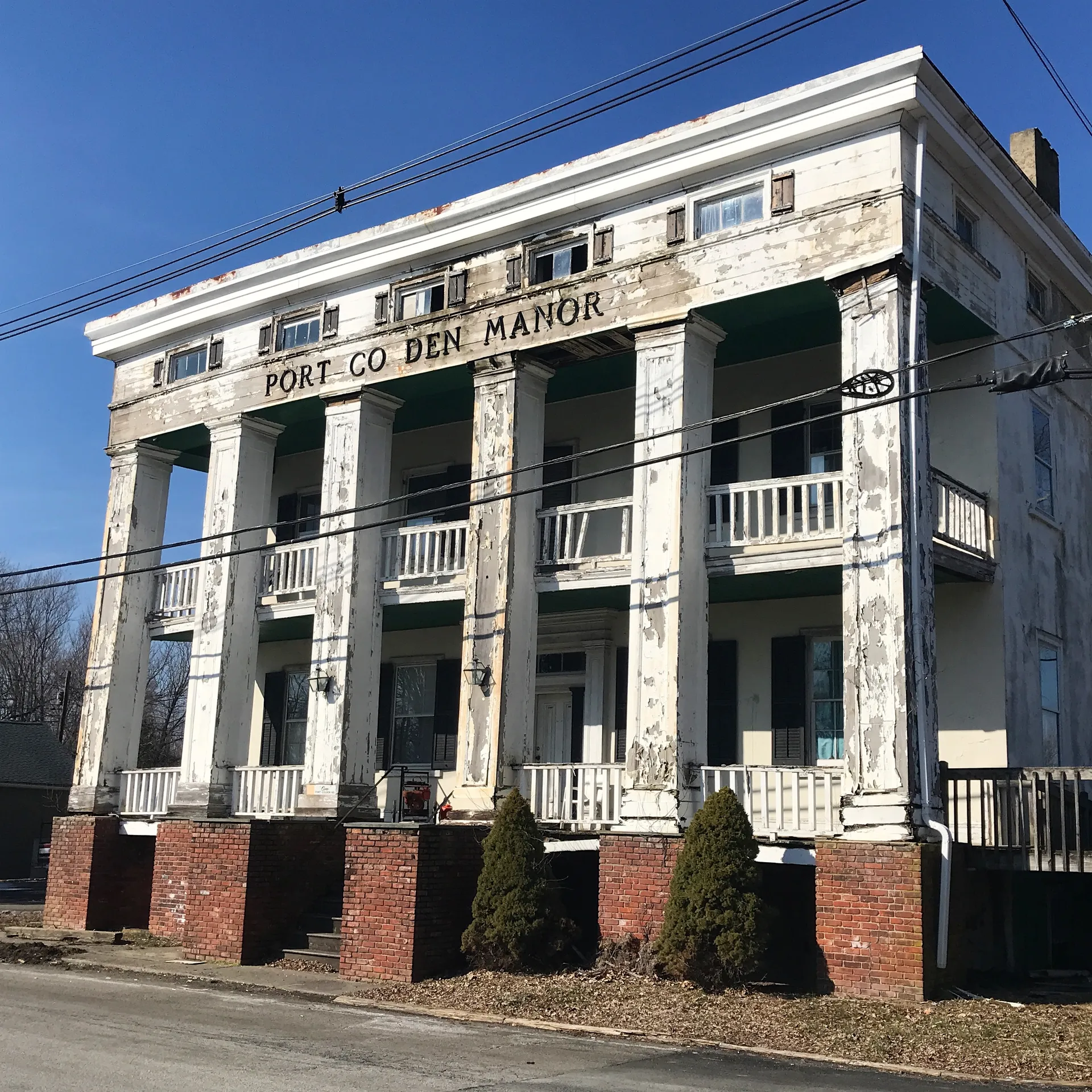 The Port Colden House is a grand white building with a tall two-story columned portico.