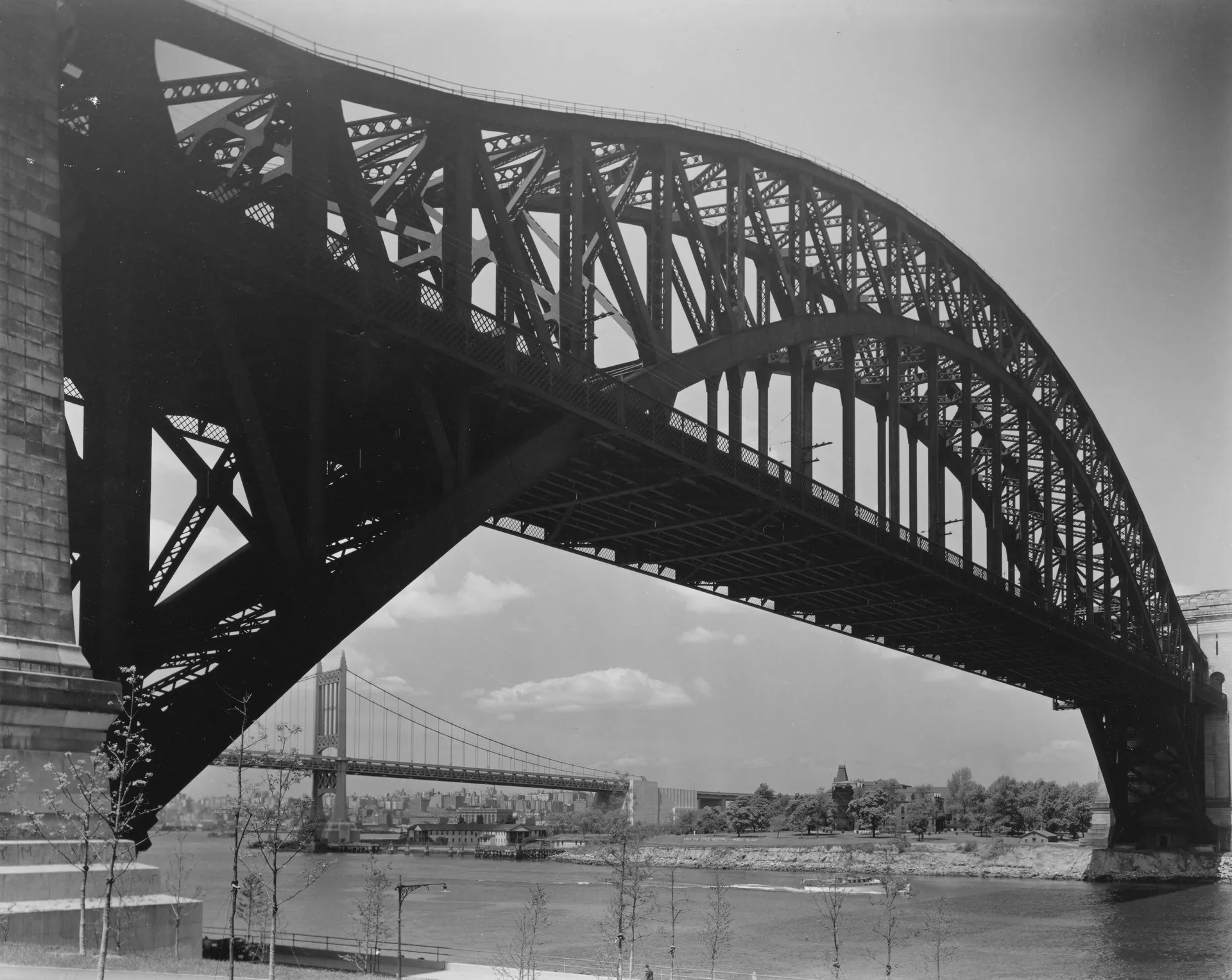 A 1937 black-and-white photograph of the Hell Gate Bridge in Astoria.