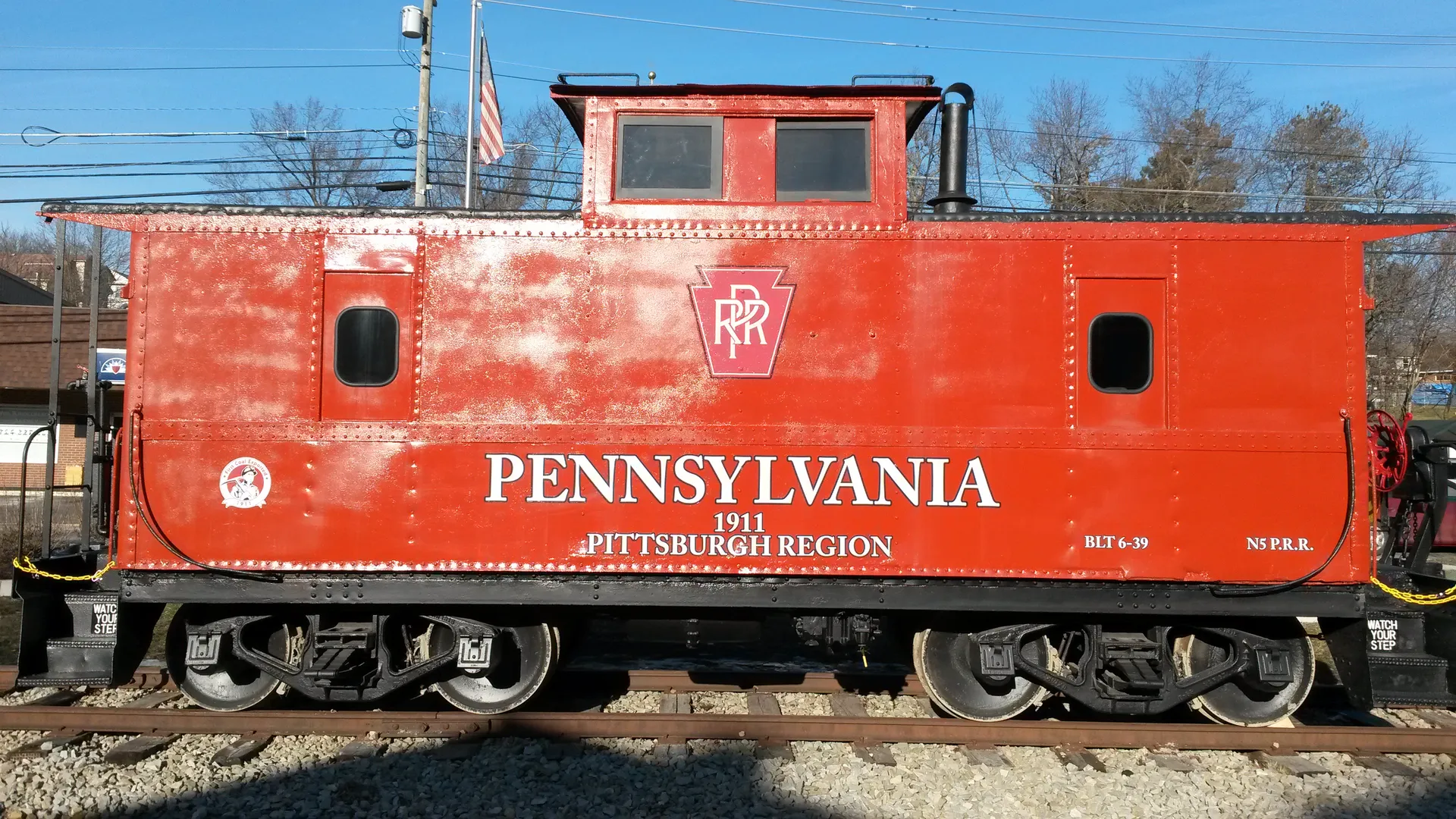 A restored red 1939 Pennsylvania Railroad caboose from the Turtle Creek Industrial Railroad sits on display in Export.
