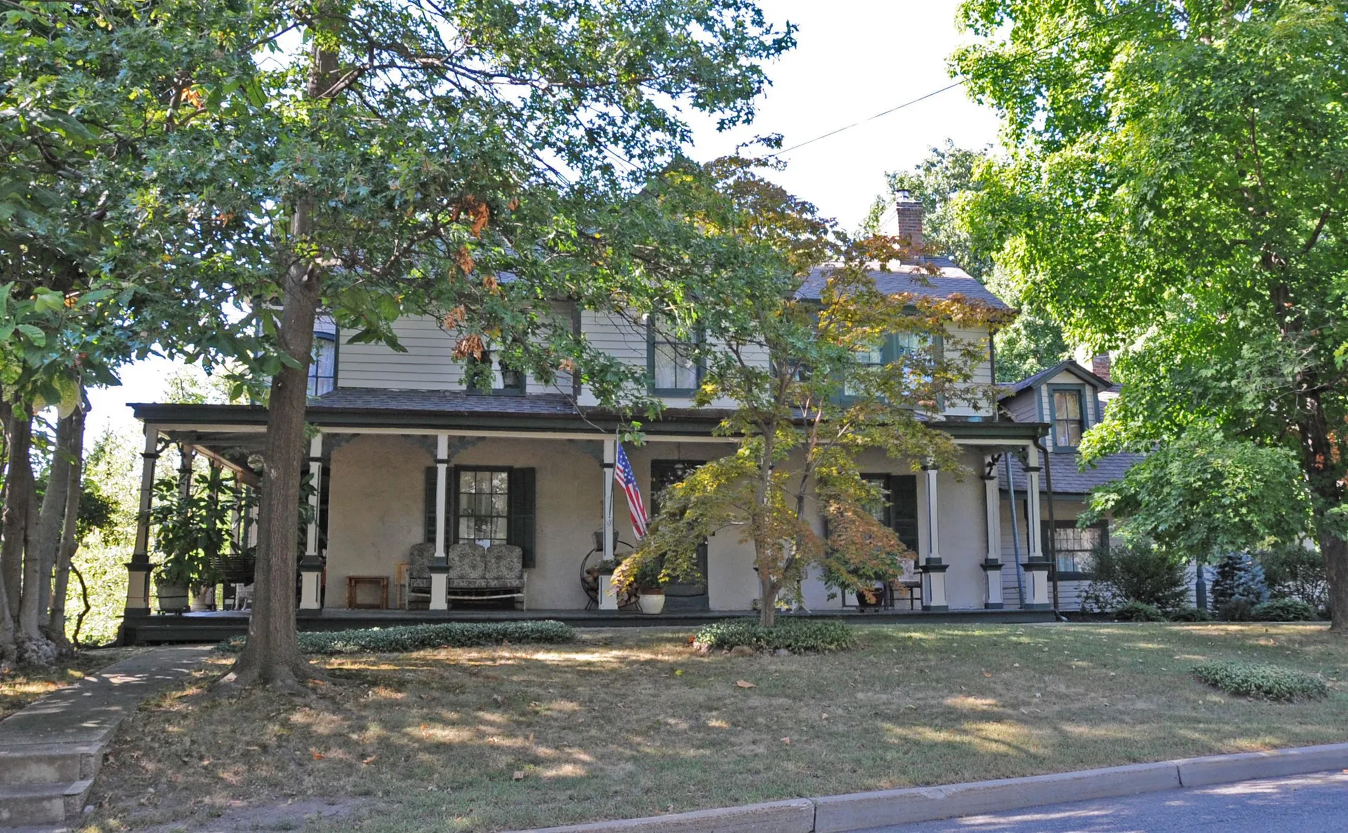 The Myers-Masker House in Midland Park is a two-story home with a deep front porch, partly screened by a leafy tree.