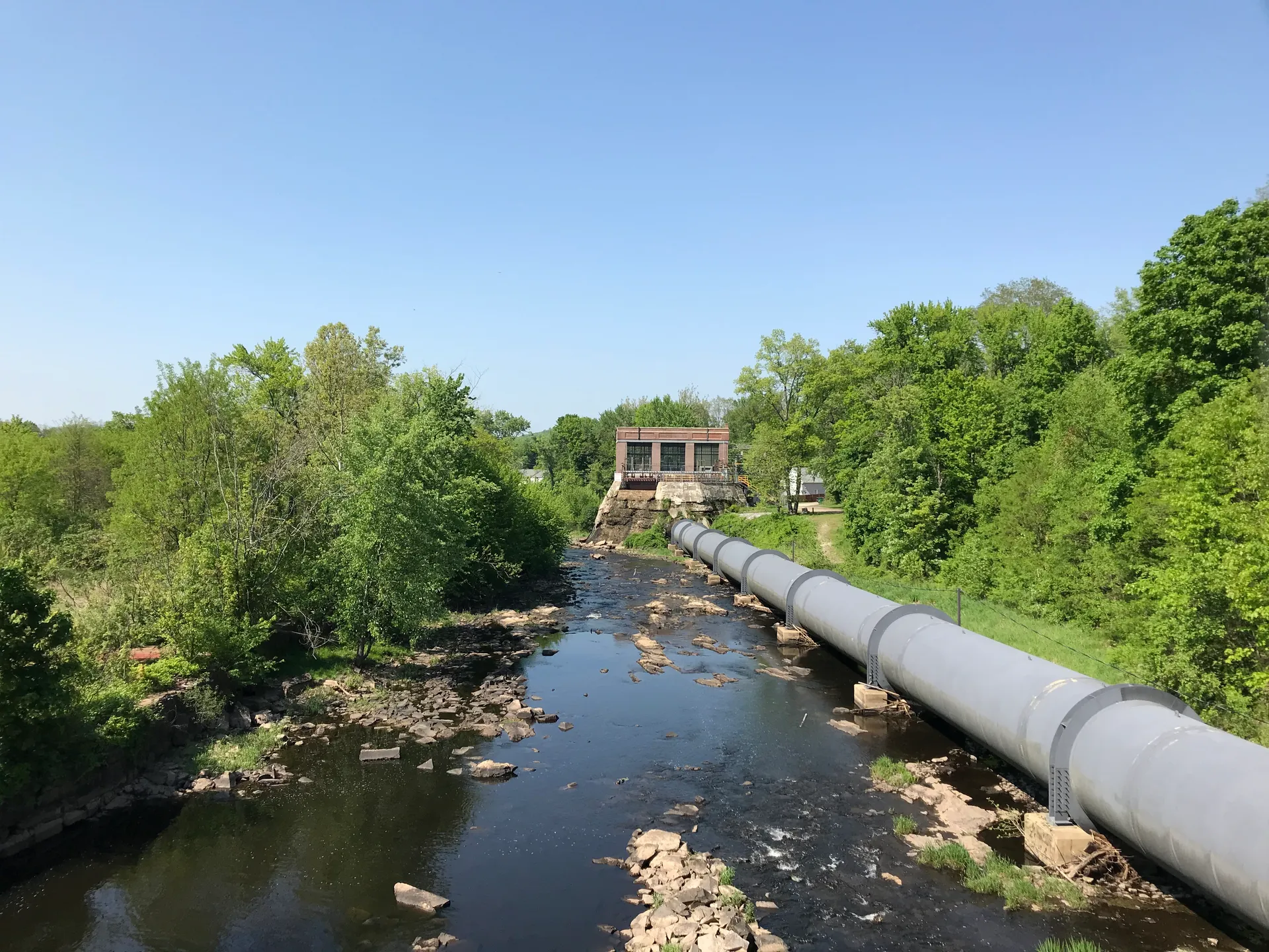 Historic penstock and powerhouse along the river in East Pepperell, Massachusetts.