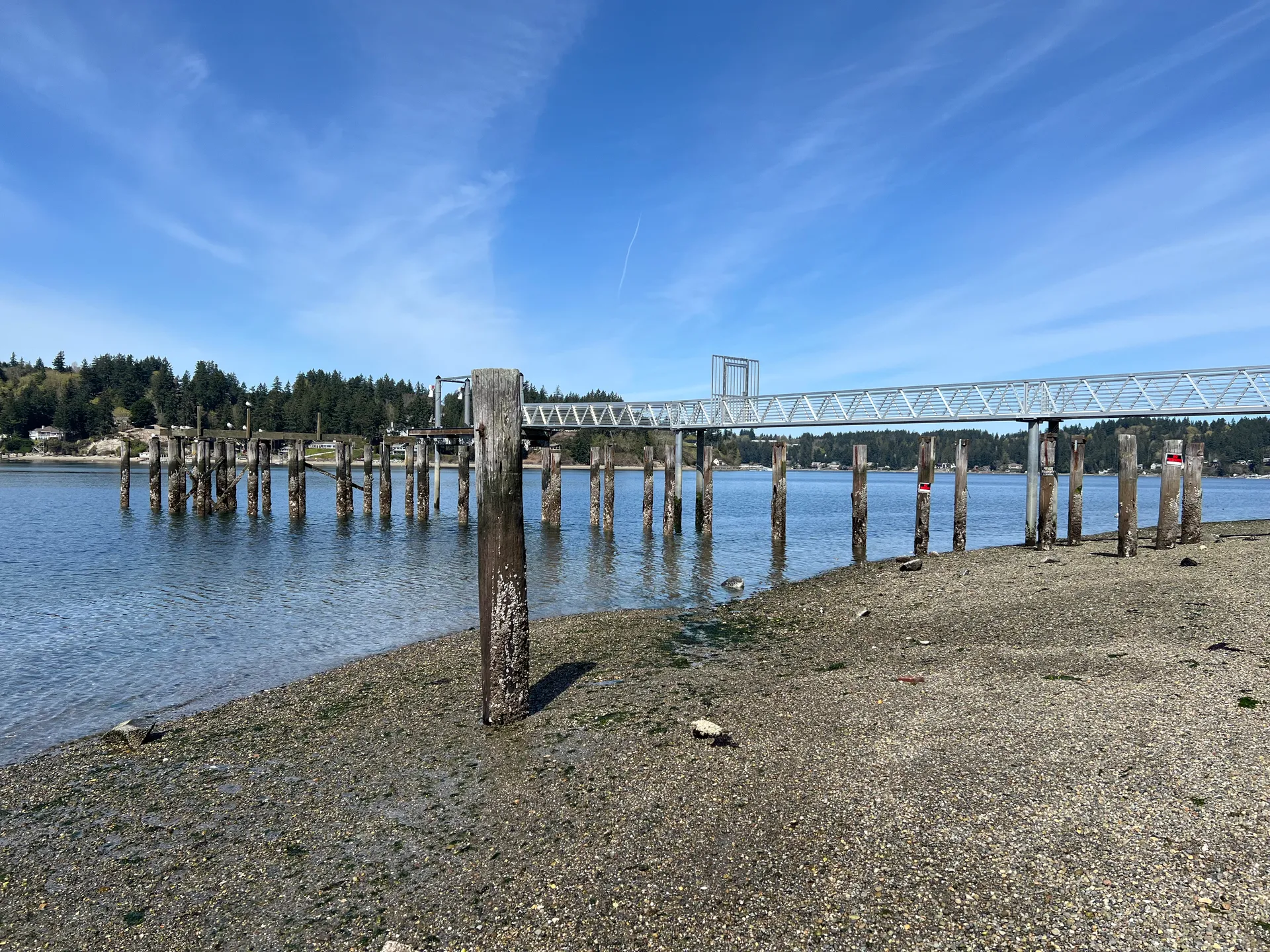 Pier and shoreline looking north from Point Fosdick in Wollochet, Washington.
