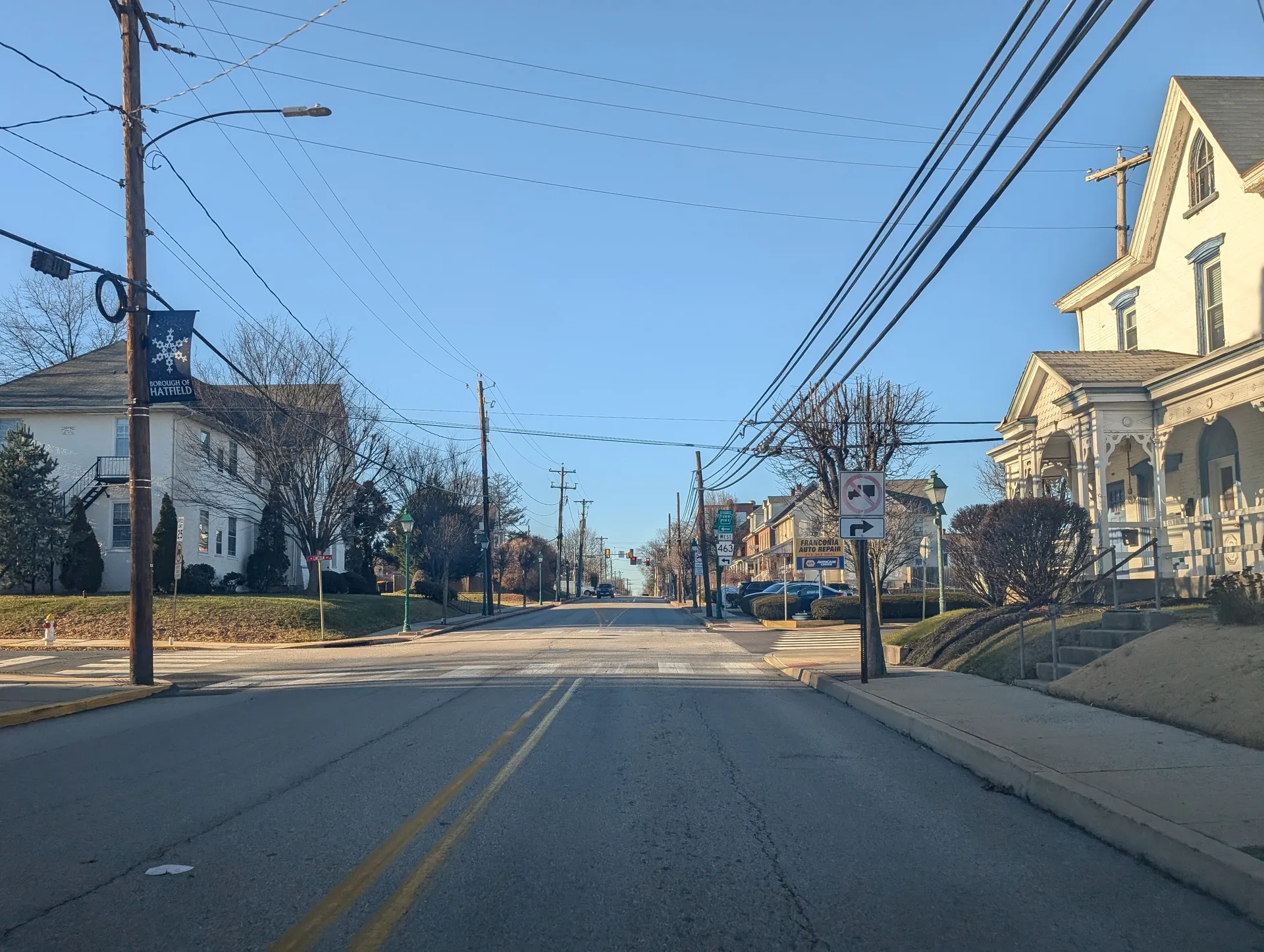 Main Street (Route 463) in Hatfield passes Victorian houses and tall utility poles between Poplar Street and Lincoln Avenue.