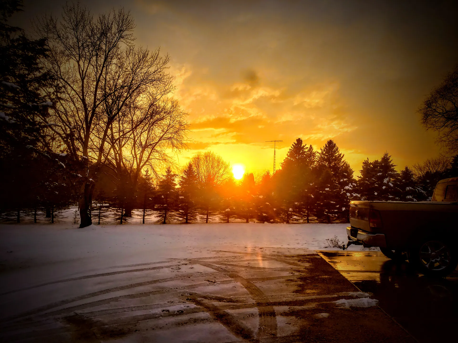 Sunset glowing over a snowy landscape at dusk in Wyocena, Wisconsin.