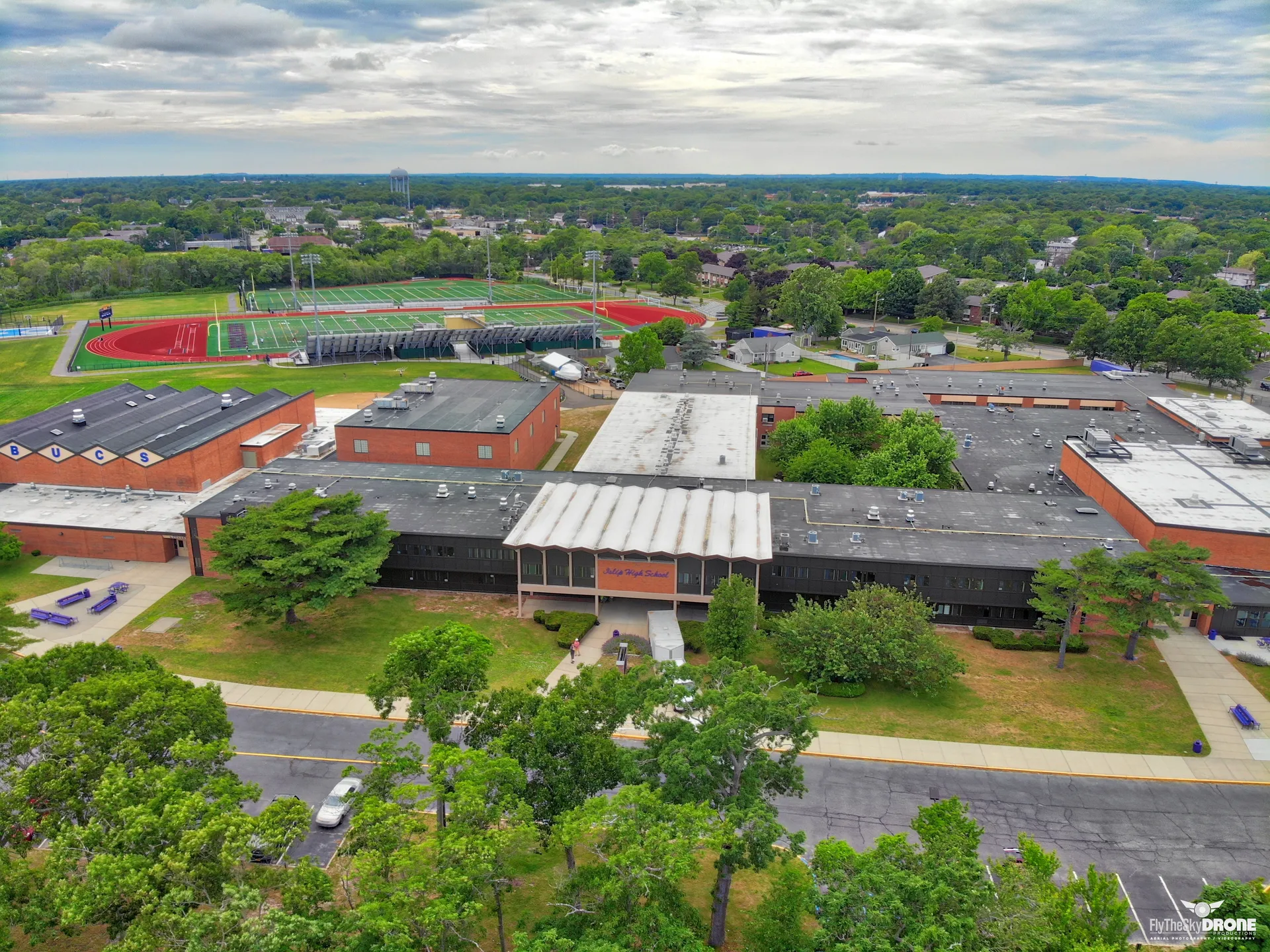 Aerial view of a school campus and neighborhood in Islip, New York.