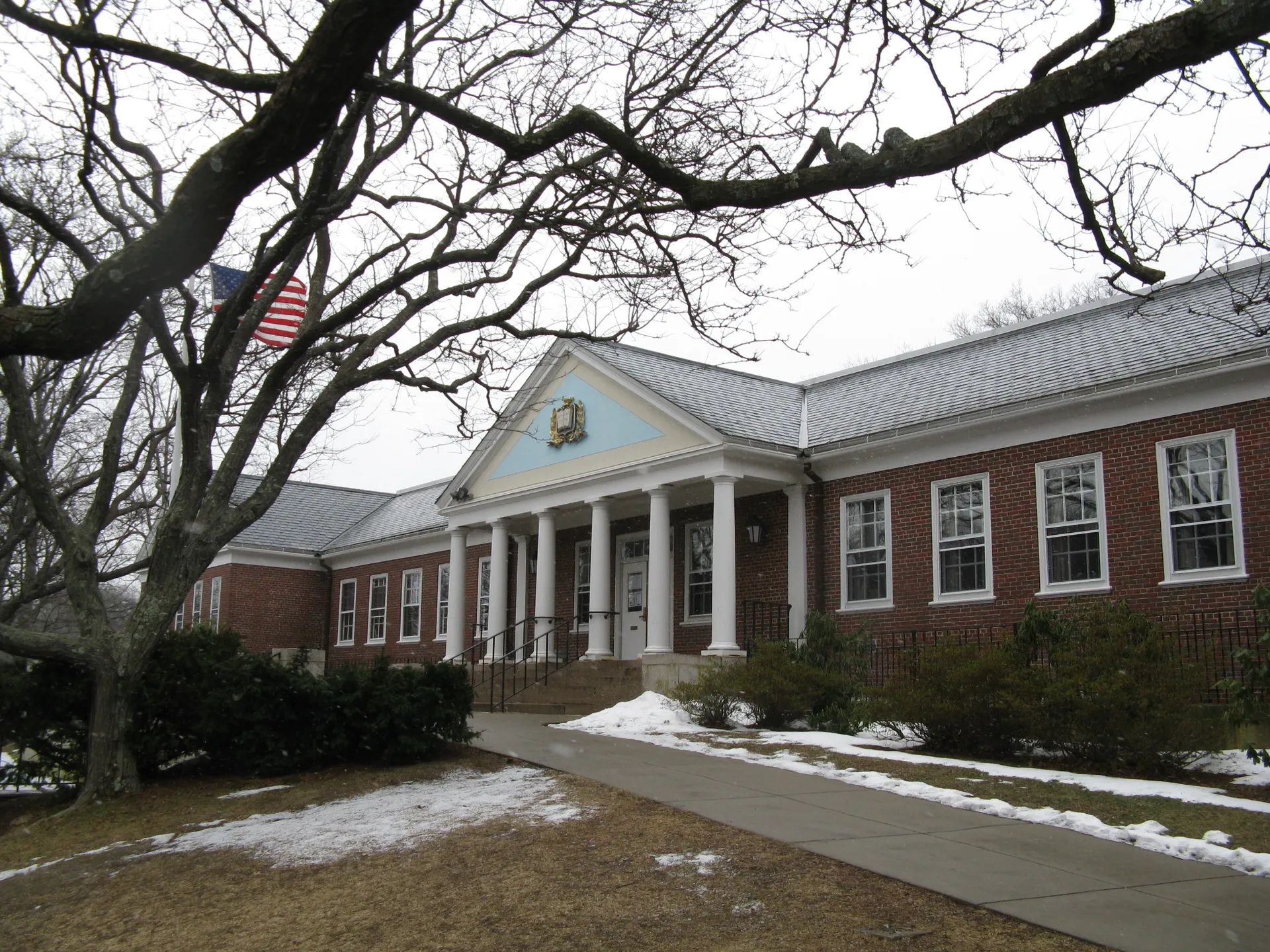 Brick Belmont Public Library with white columns in Belmont, Massachusetts.