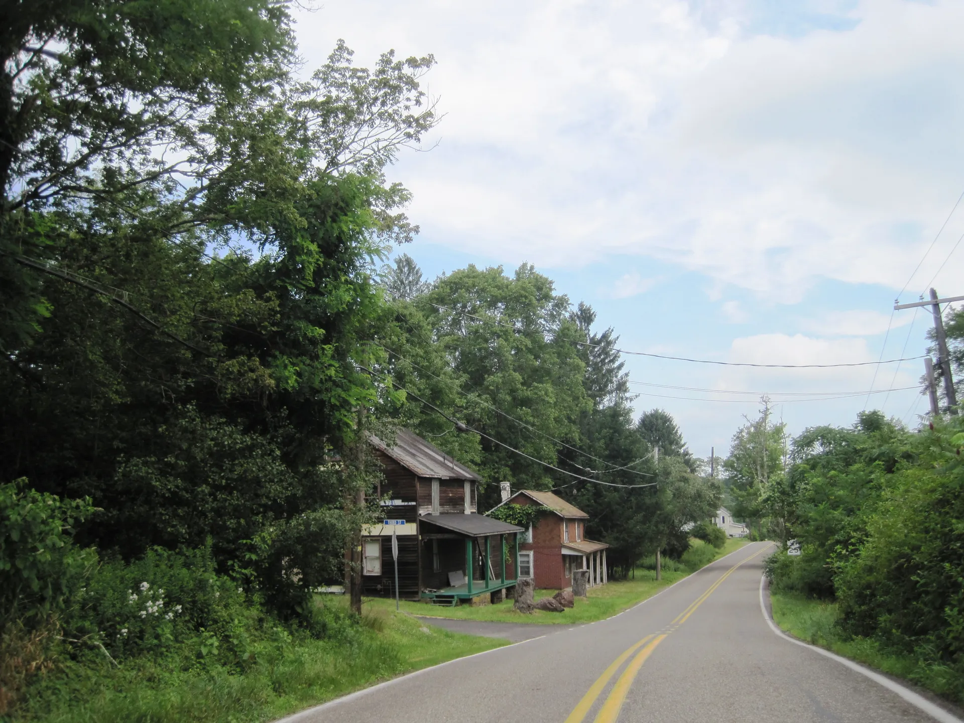 Chestnut Street winds north through the village of Middleburg in Dennison Township, passing older homes beneath tall trees.