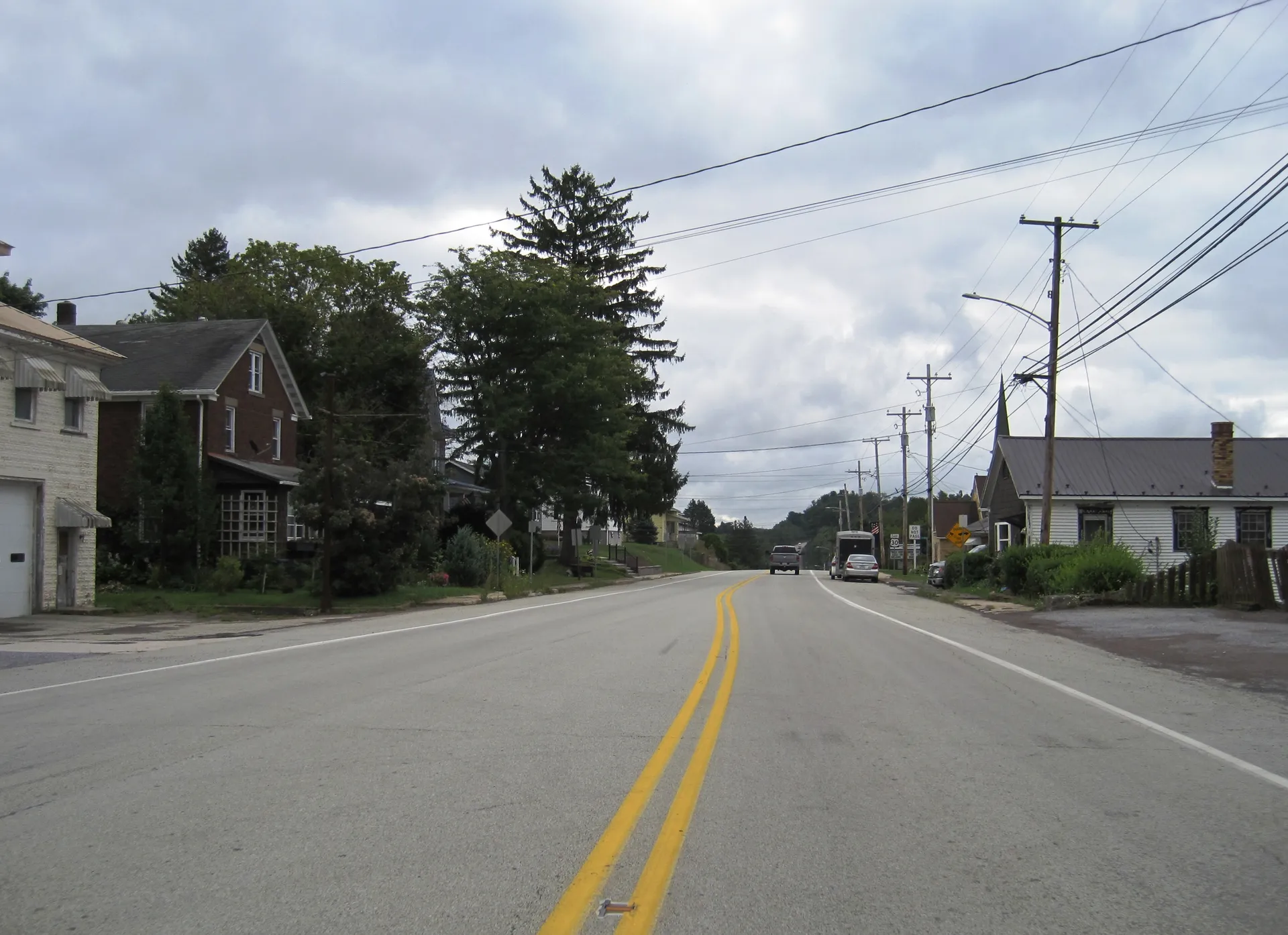 East Pitt Street carries the Lincoln Highway through Jennerstown past older homes and tall trees.