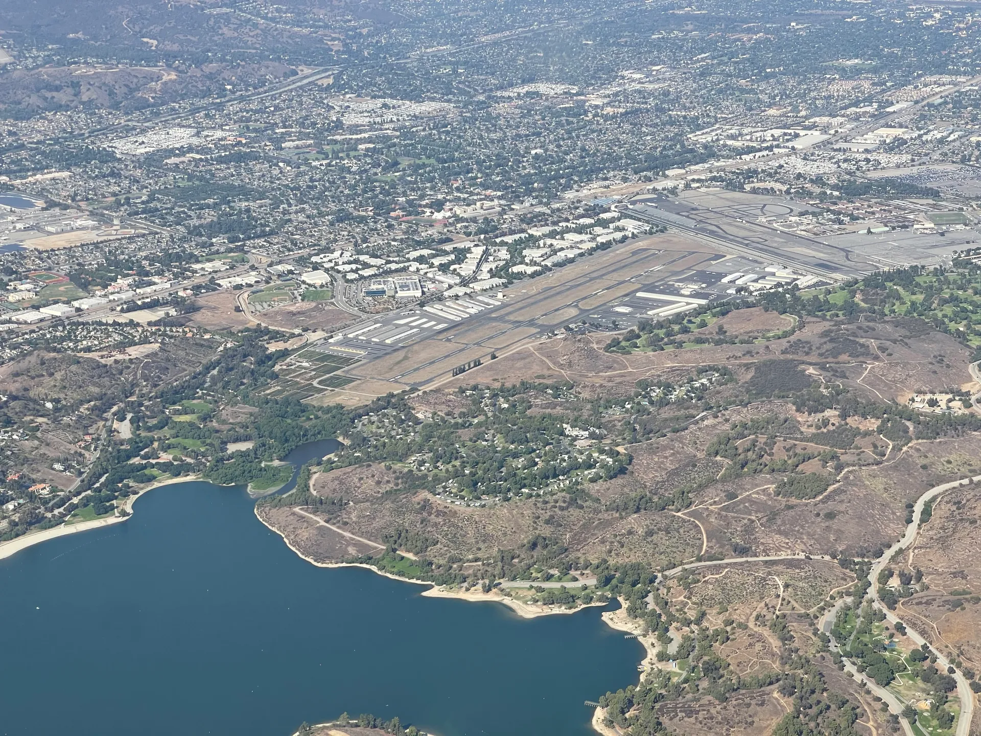 Aerial view of Brackett Field airport and Puddingstone Reservoir in La Verne, California.
