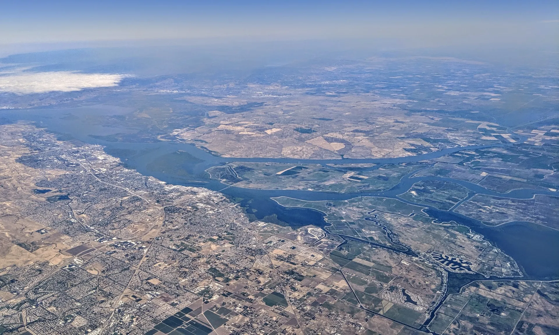 Aerial view of the confluence of the San Joaquin and Sacramento RIvers, with Antioch, California, on the near shore of the San Joaquin at the confluence