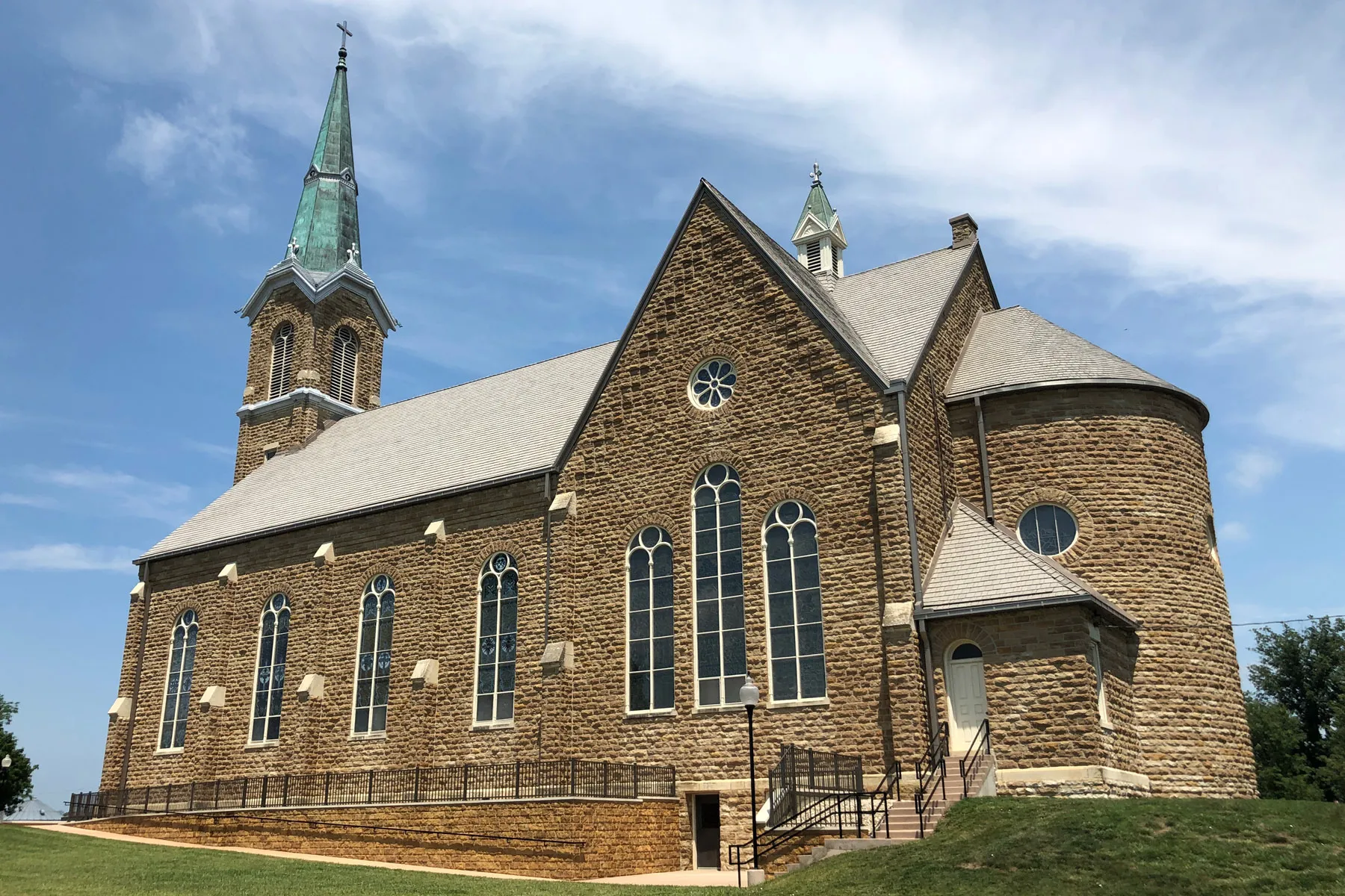Historic stone St. Mary's Church with twin towers in St. Benedict, Kansas.