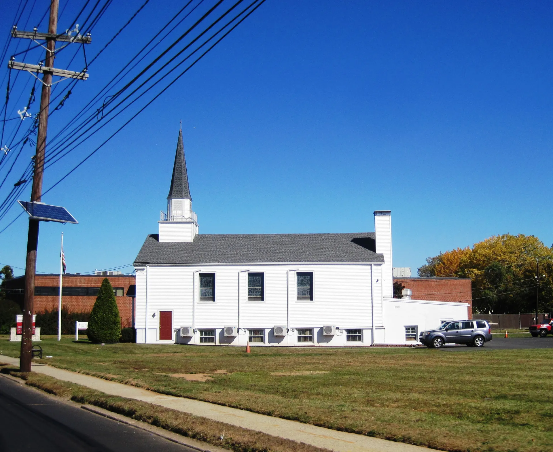 First Presbyterian Church of Moonachie is a white church with a slender steeple and a long side wing.