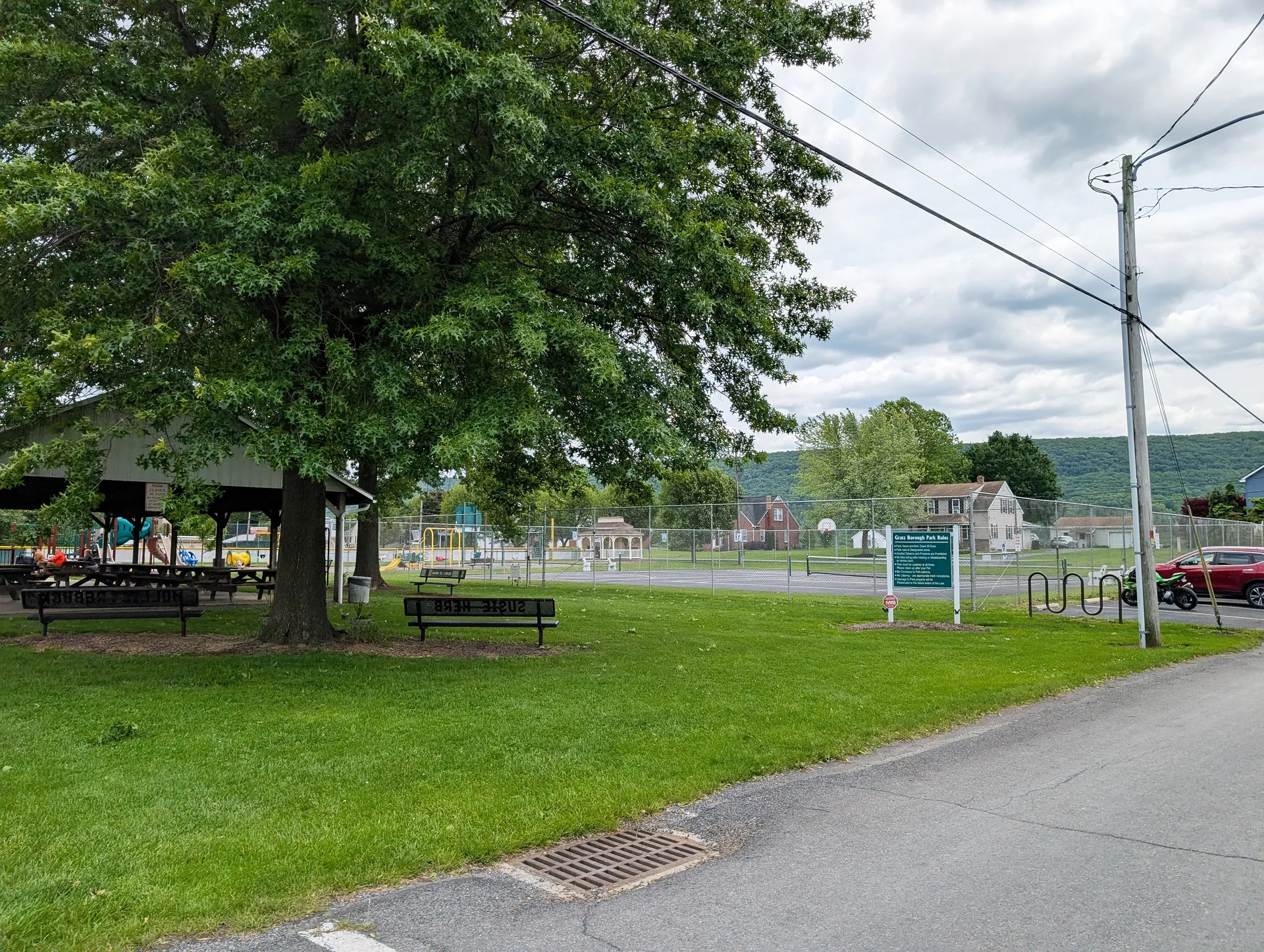 Gratz Borough Park offers a grassy lawn, picnic tables and a large shade tree along South Central Street.