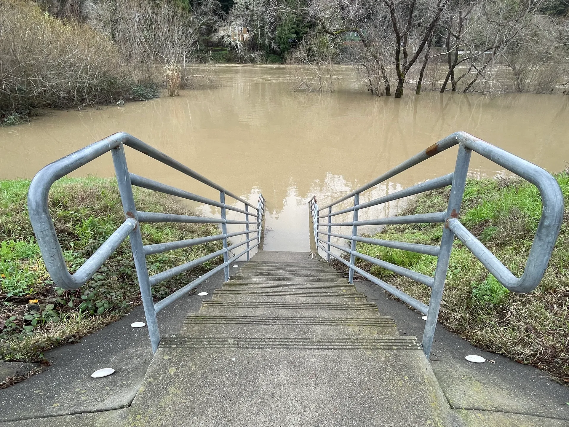 Steps leading into the flooded Russian River in Monte Rio, California, in January 2023.