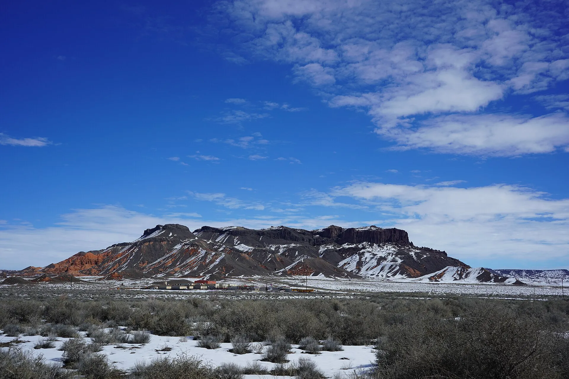 The photograph shows Bidahochi Butte with Indian Wells Elementary School below. Photograph was taken on 2019-02-27T19:33:11Z.