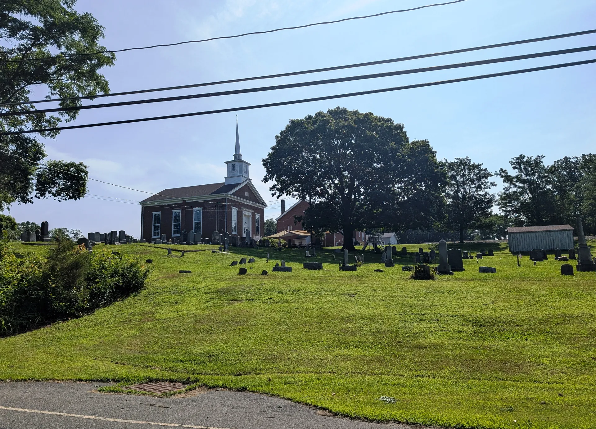 Jacobstown Baptist Church in North Hanover Township is a white church with a steeple beside a grassy cemetery.