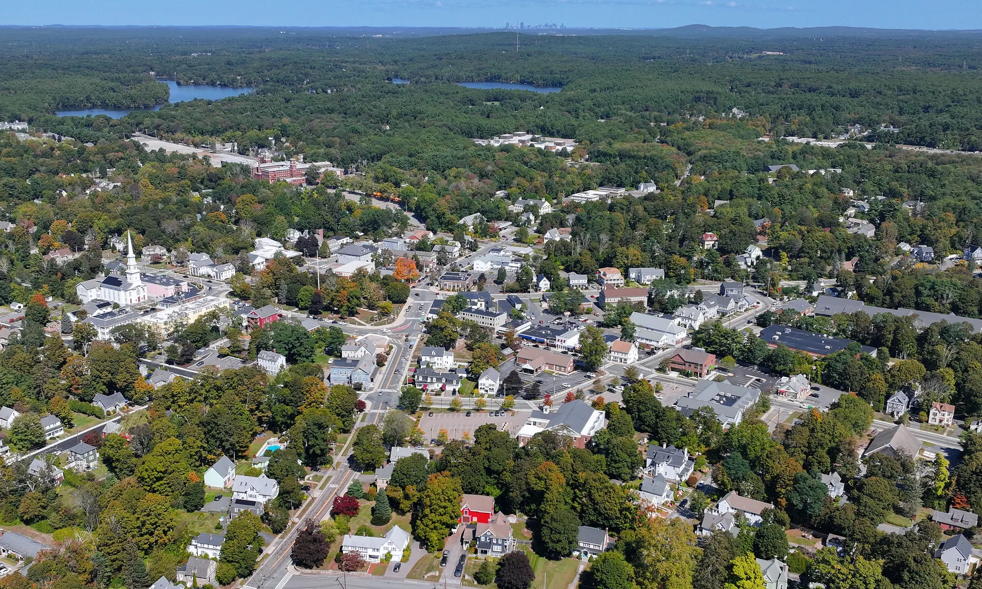 Aerial view of Foxborough, Massachusetts, surrounded by trees.